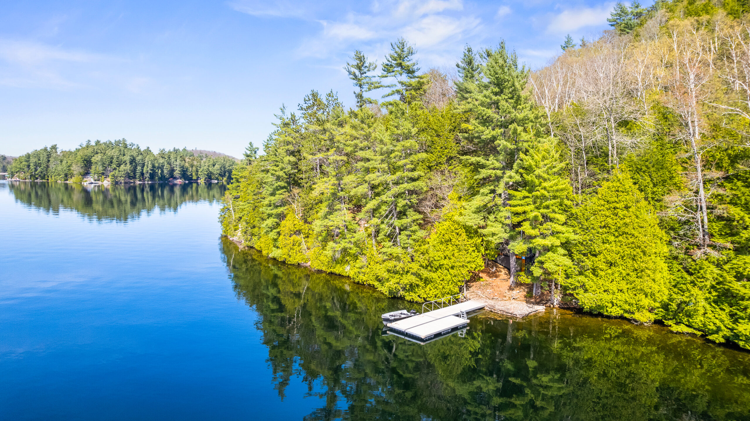Aerial view of the property with the dock floating in the water