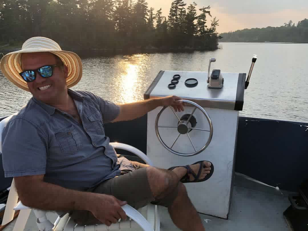 Jeremy Brown at the wheel of his houseboat coffee roastery