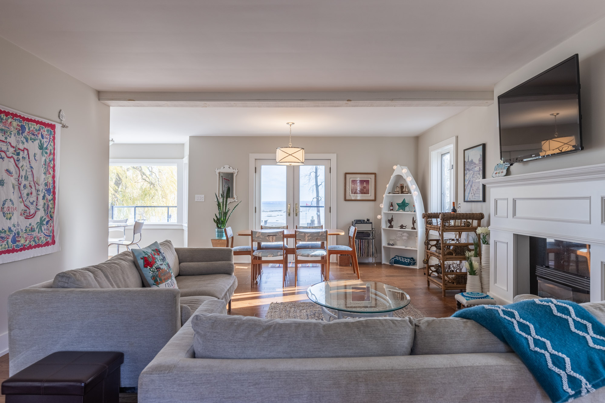 The other perpendicular couch faces the dining room and large windows that showcase the lake