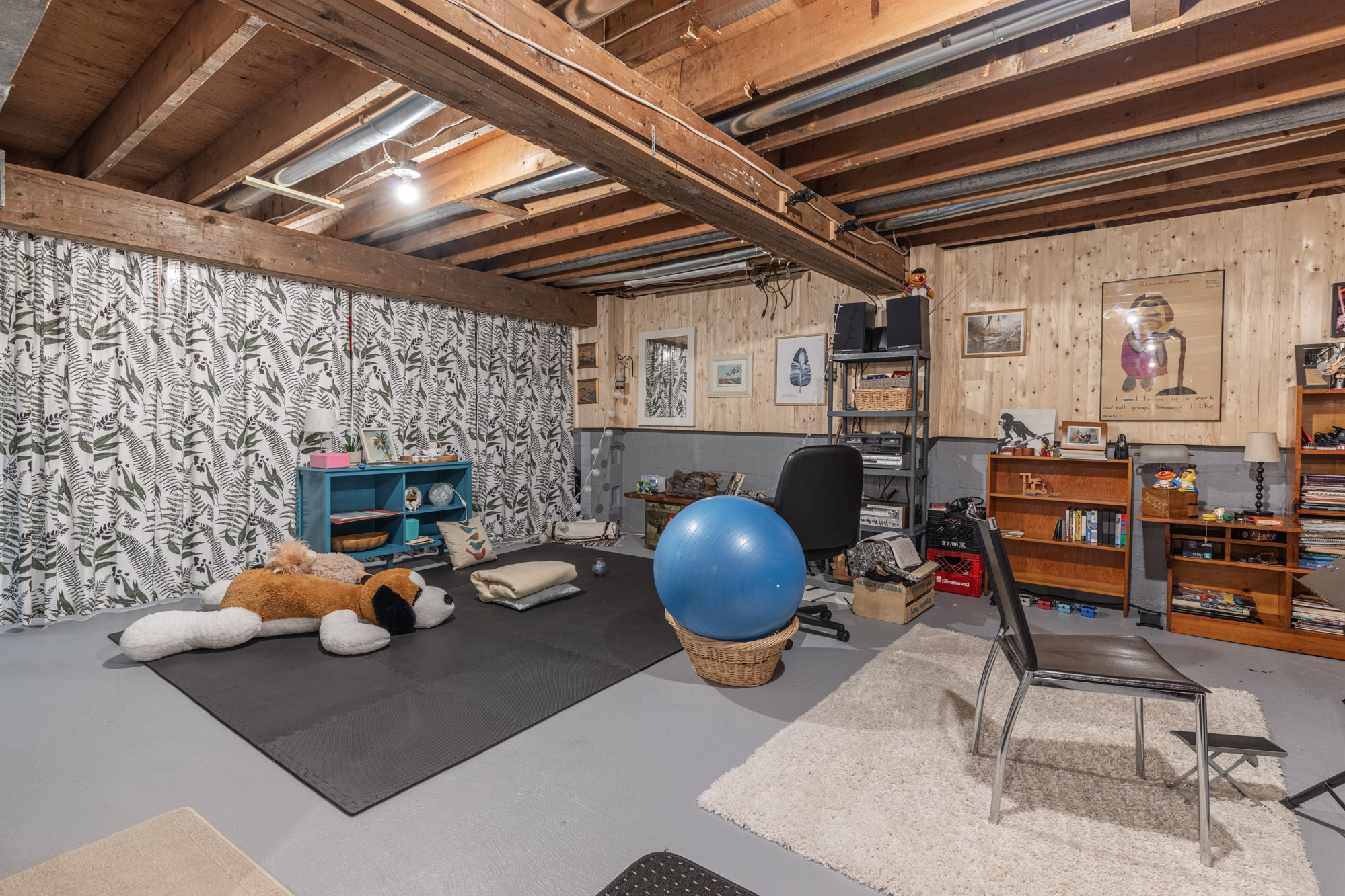 Unfinished basement features a gym area