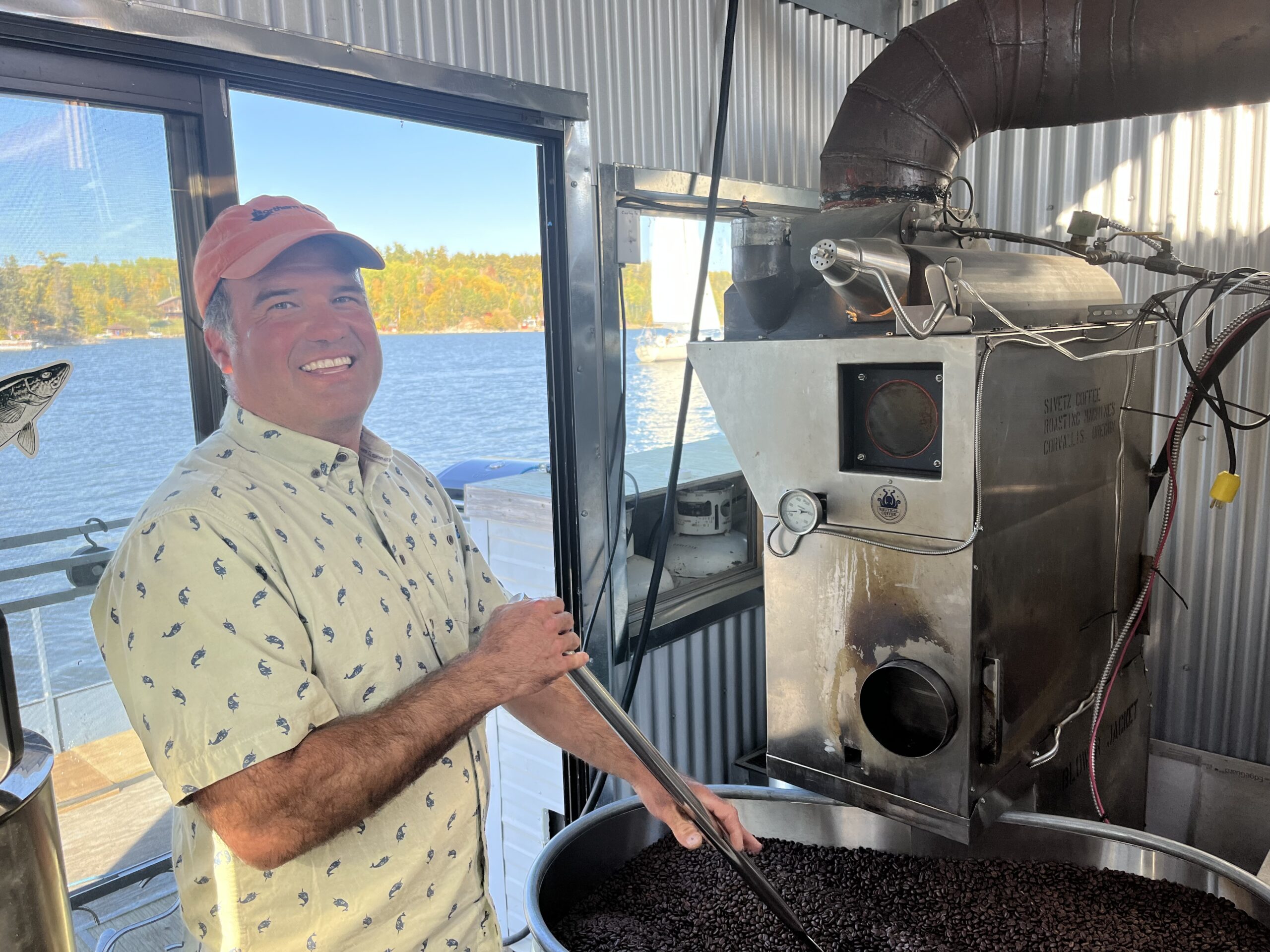 Jeremy Brown stirring beans into the coffee roaster