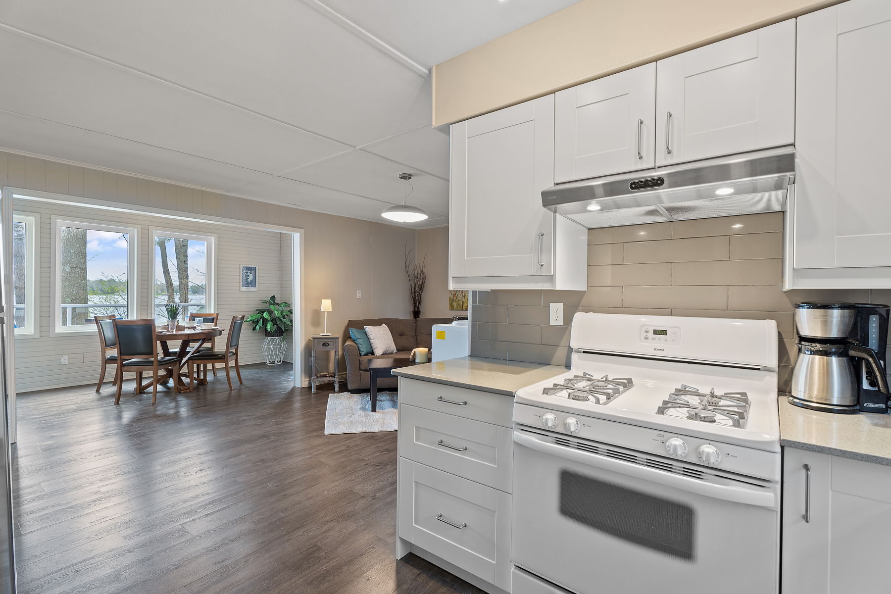 A bright, open-concept area with a kitchen, a dining area, and a living area.