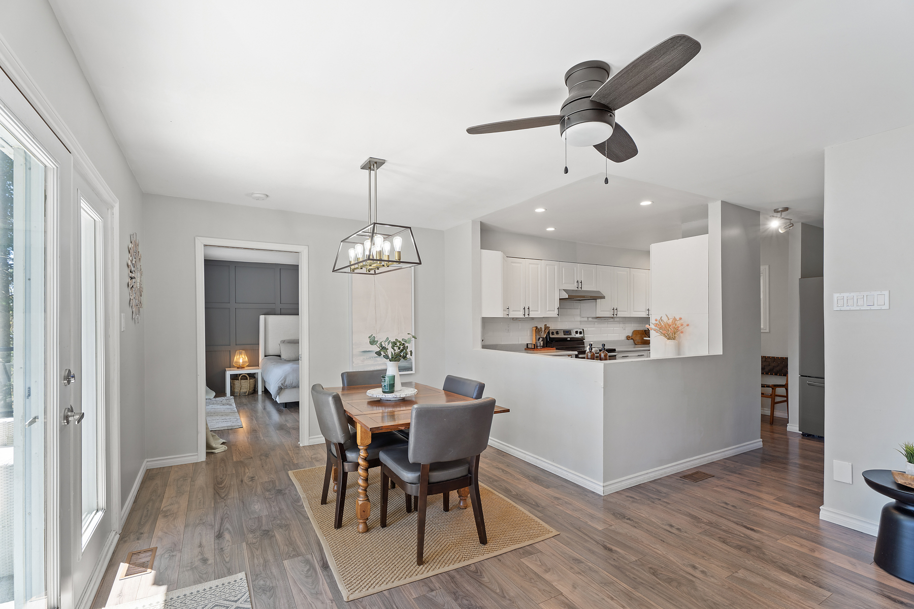 A small brown dining table sits next to the kitchen