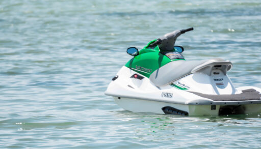 A white and green jet ski on the water