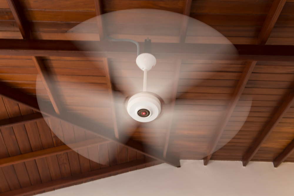 A rotating ceiling fan photographed from underneath