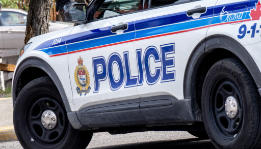 A close up of the side of a white SUV with the words "Police" in blue