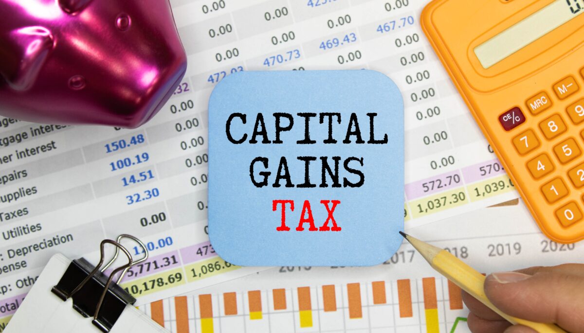 A printed spreadsheet with a blue square on top that reads "Capital gains tax"