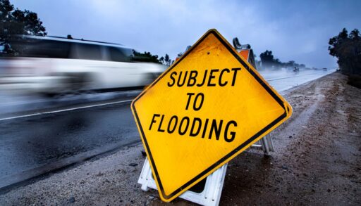 yellow warning sign that says "subject to flooding"