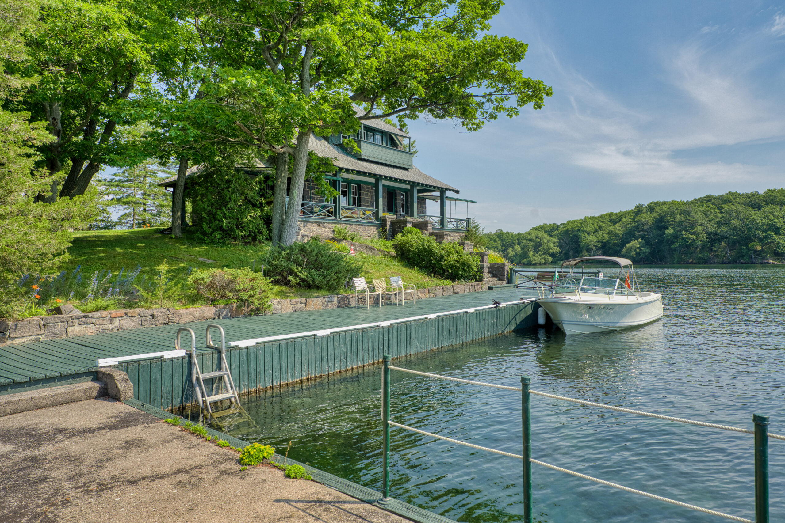 A green dock on the shoreline of the property