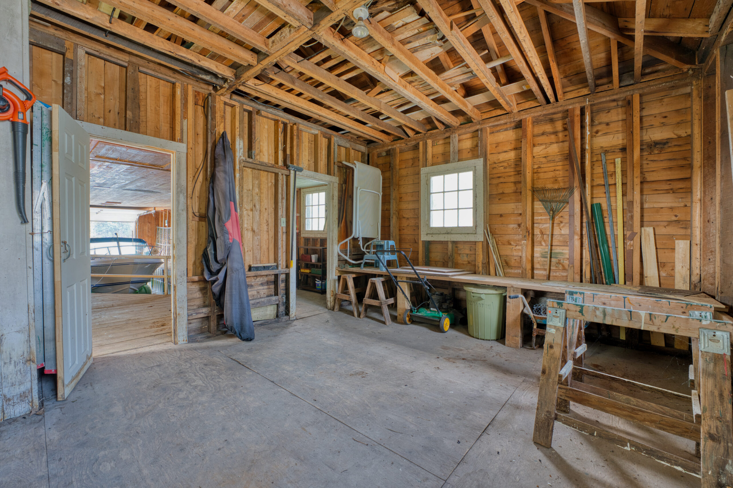 Inside the boathouse, an unfinished interior with wood beams