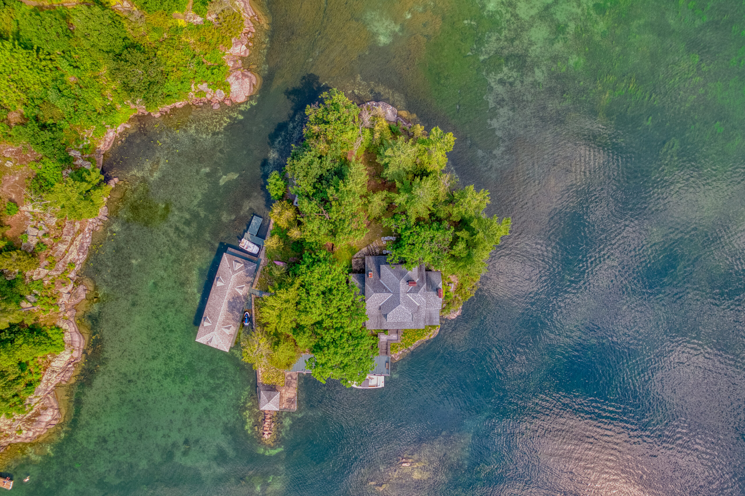 aerial view of a lush green island surrounded by turquoise water