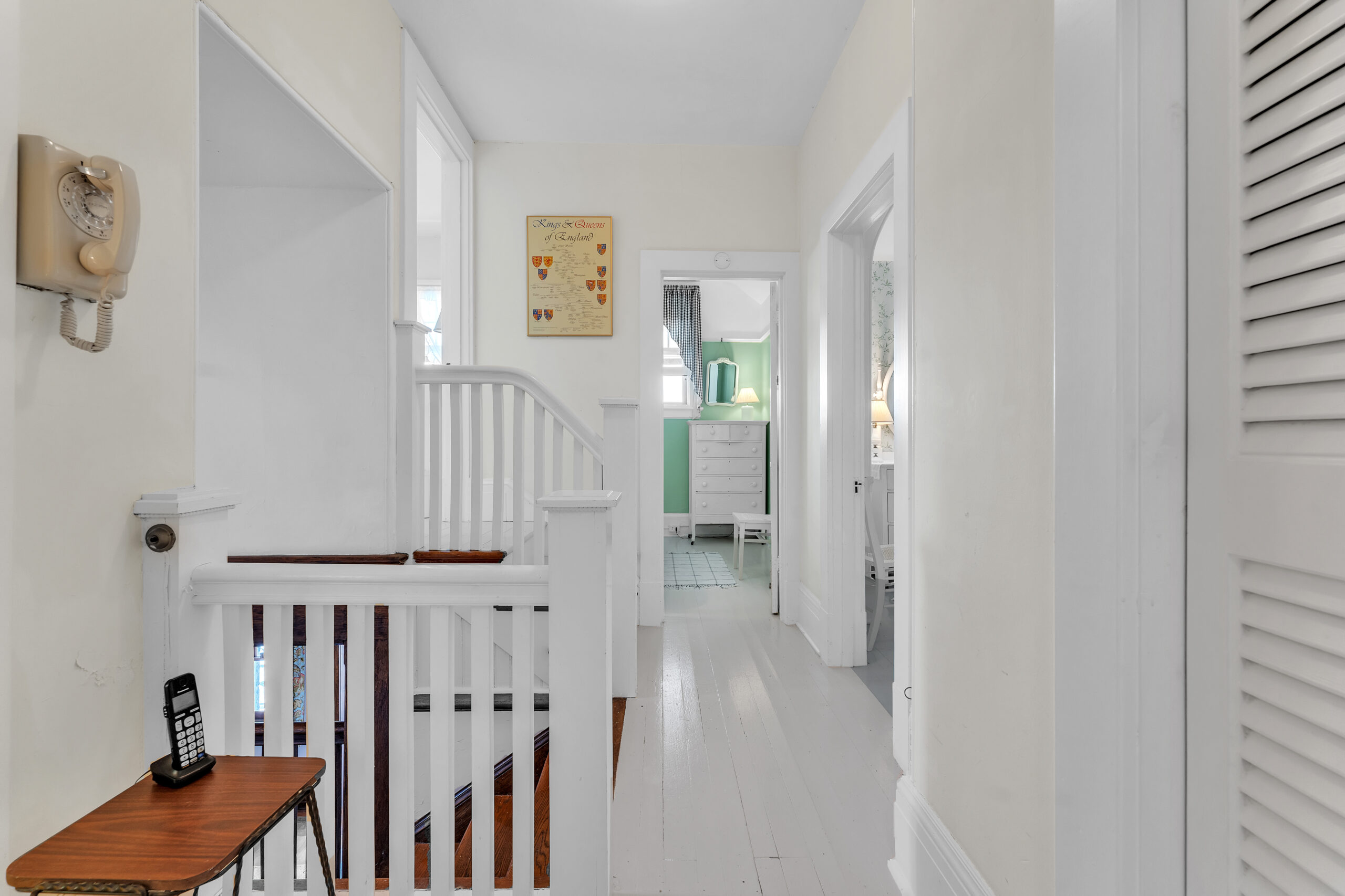 A white second floor landing with entrances to other rooms