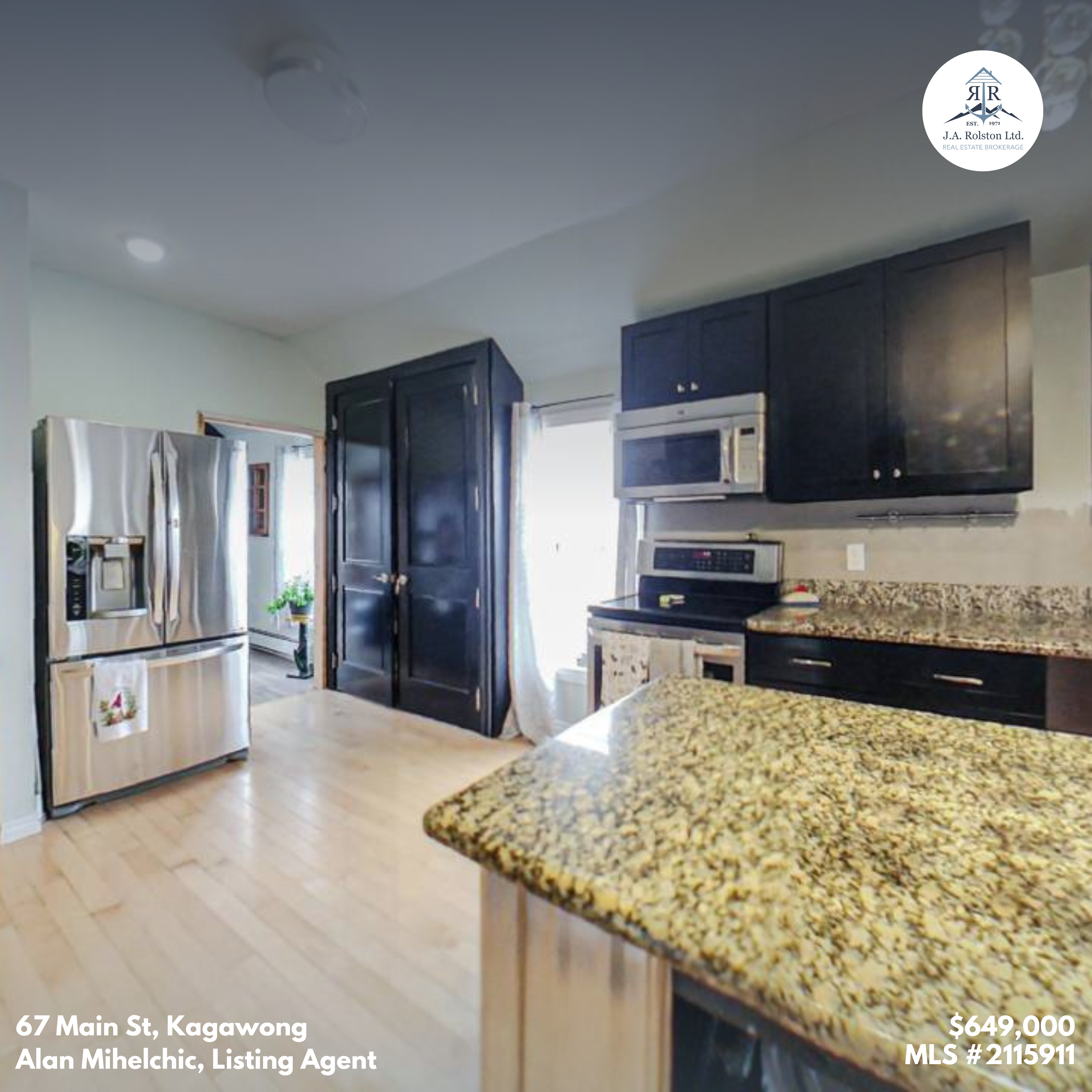A stainless steel fridge faces a kitchen island