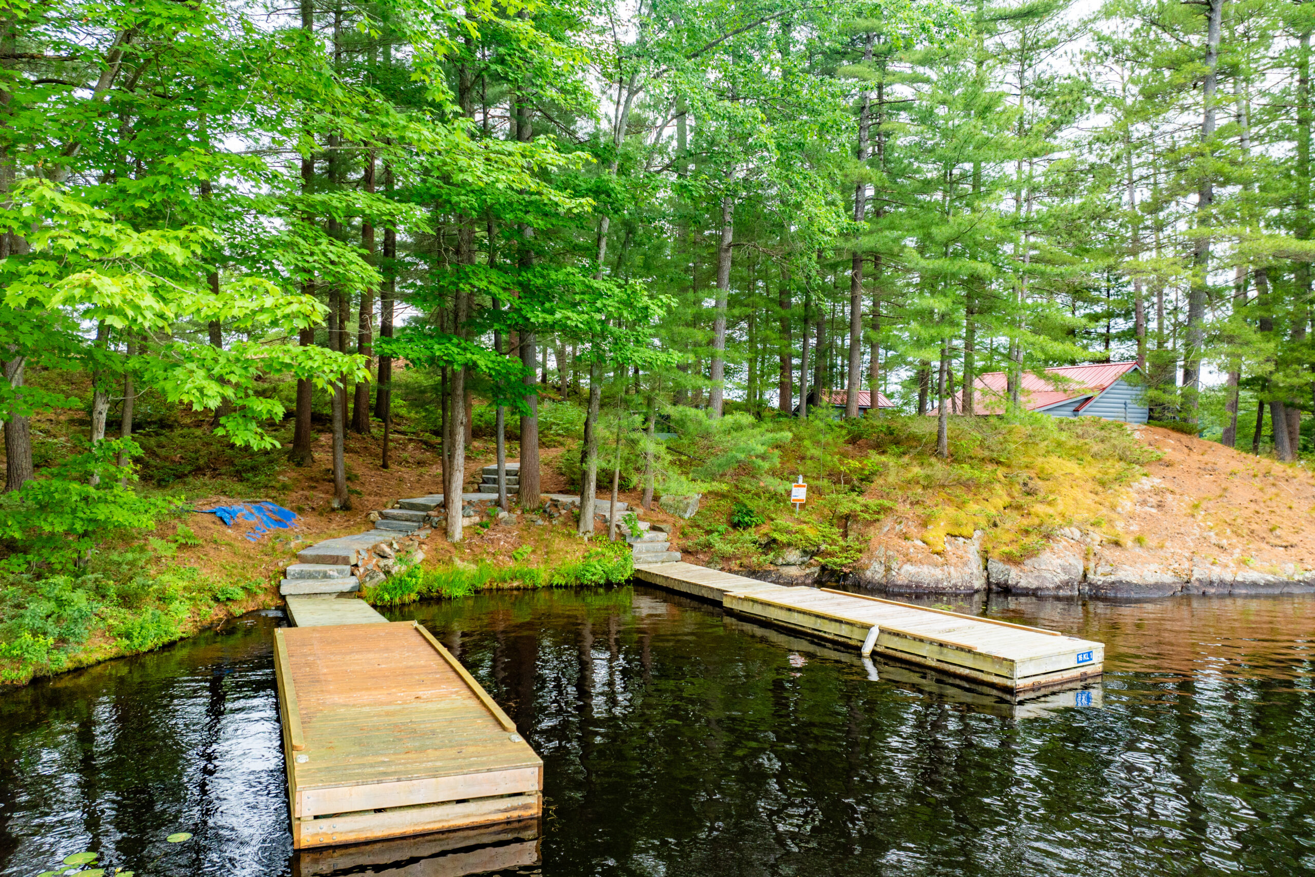Two wood docks sit on the still, black water