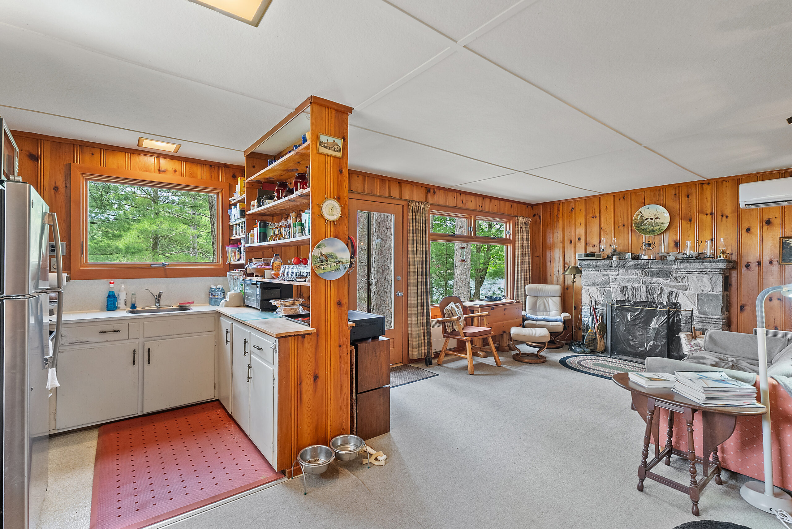 A kitchen with a half-dividing wall faces the living area