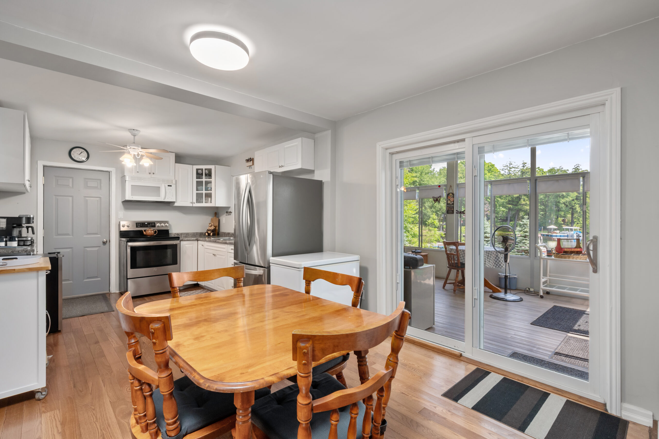 A wood dining table with a kitchen behind