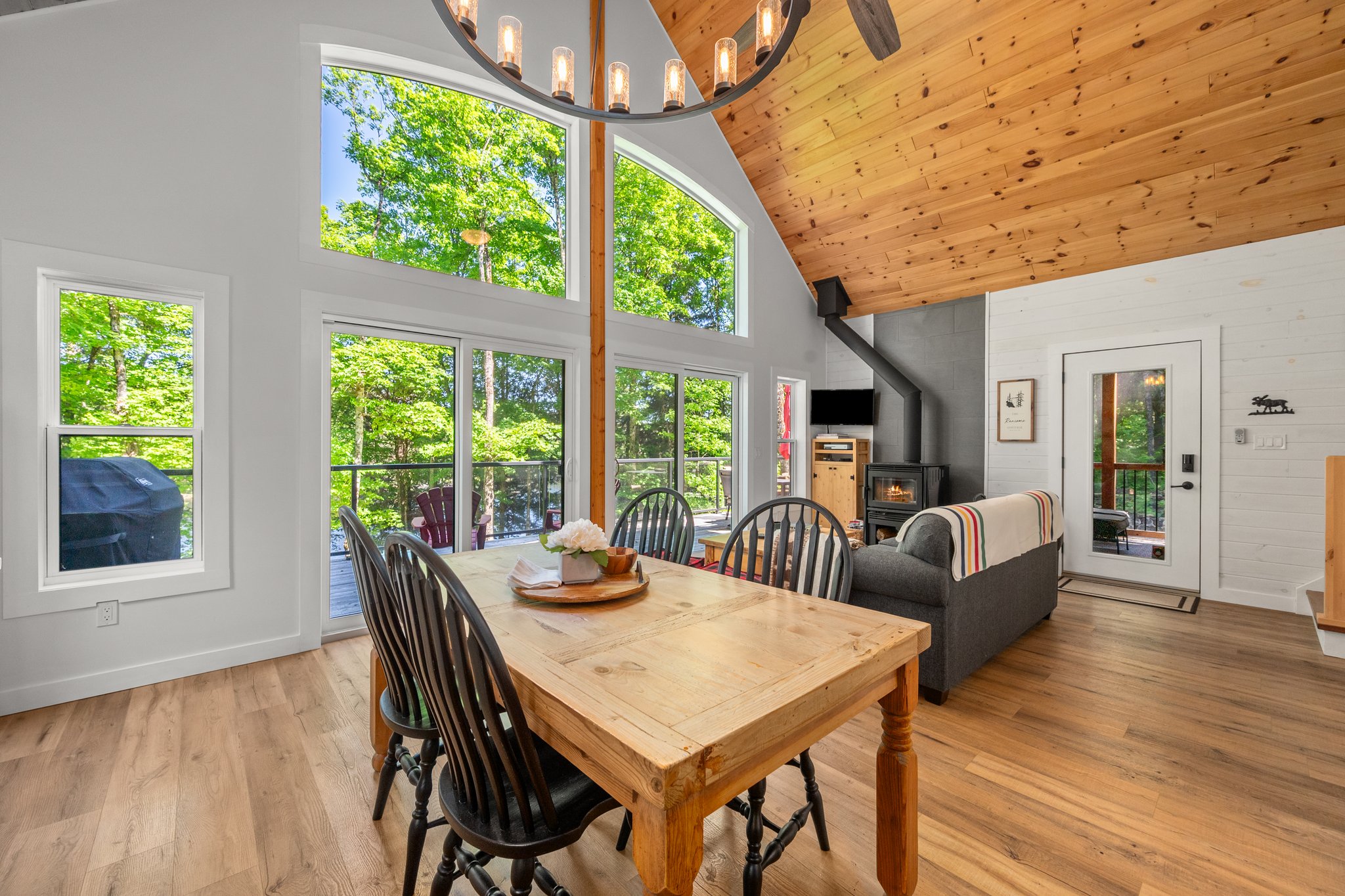 A wood dining table with grey chairs