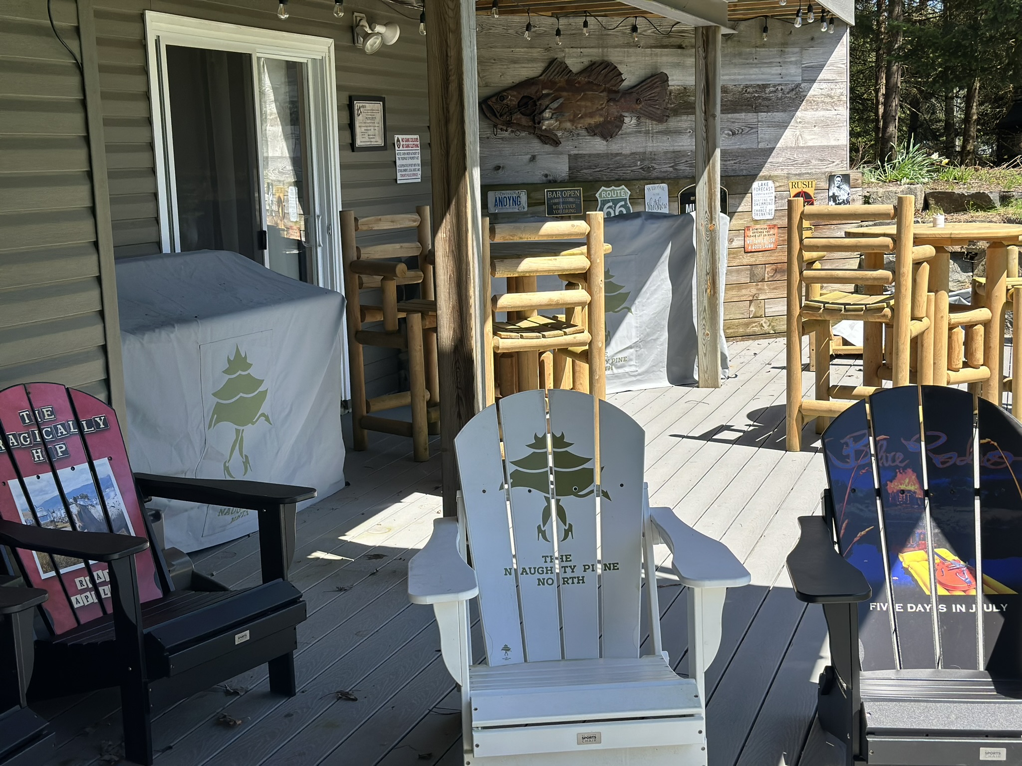 a photo of muskoka chairs outside