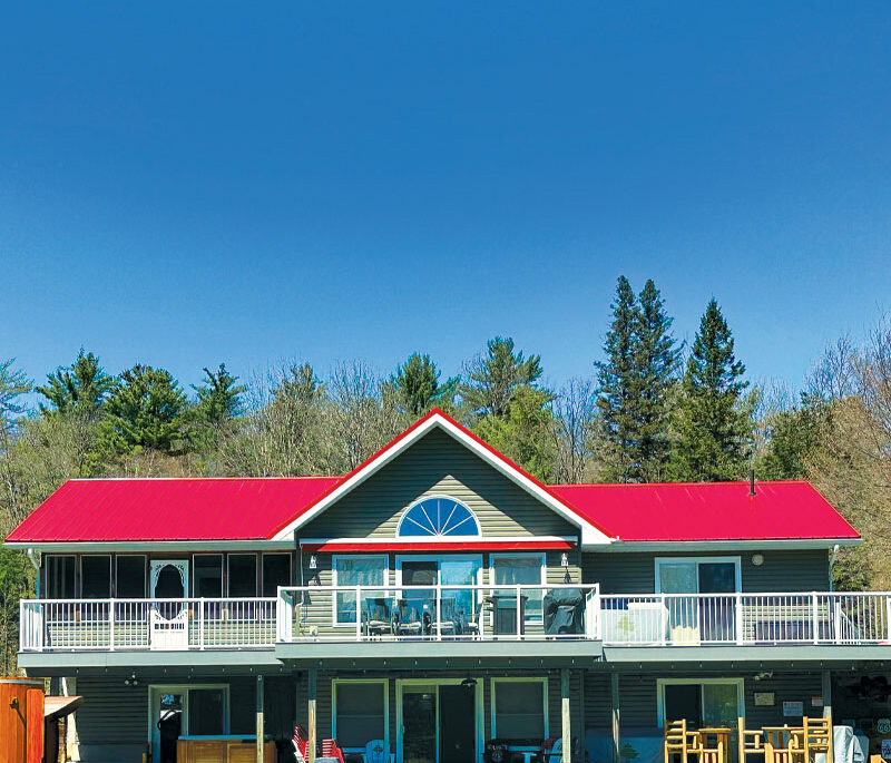 a portrait photo of a cottage with a red roof