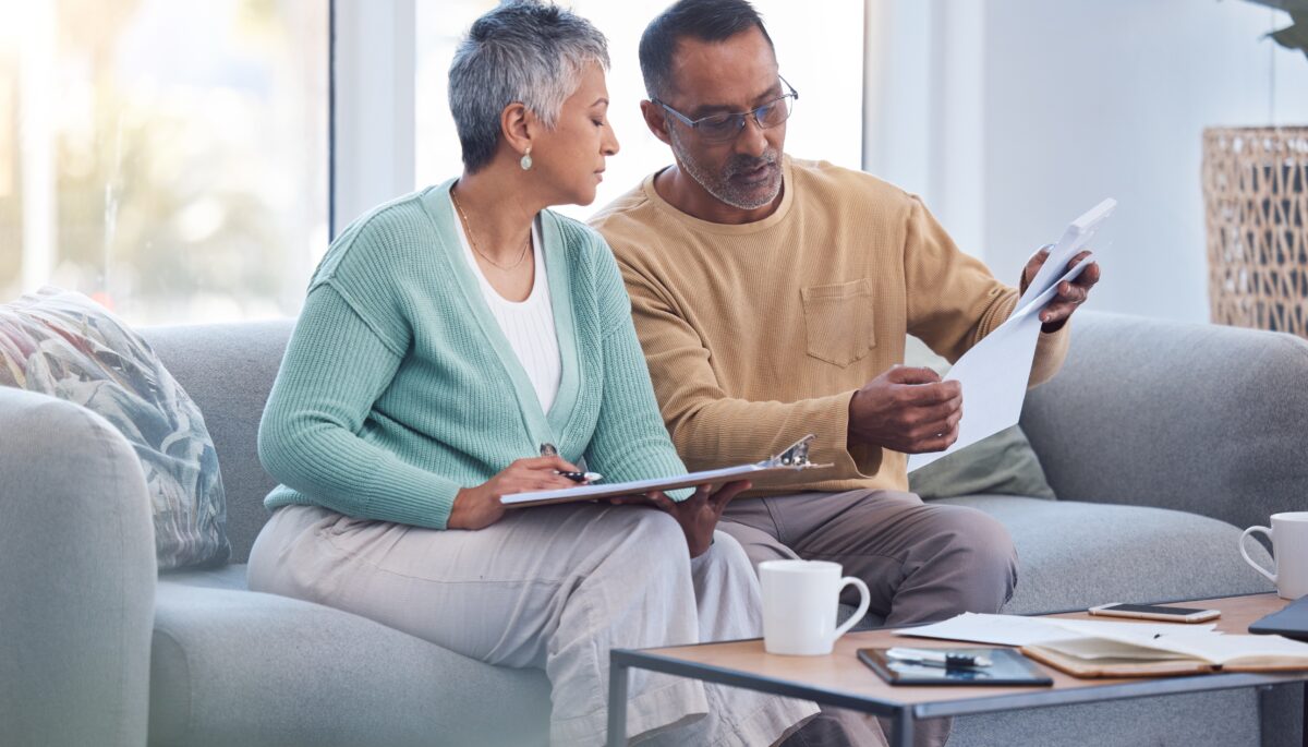 a photo of a couple looking at papers and making calculations