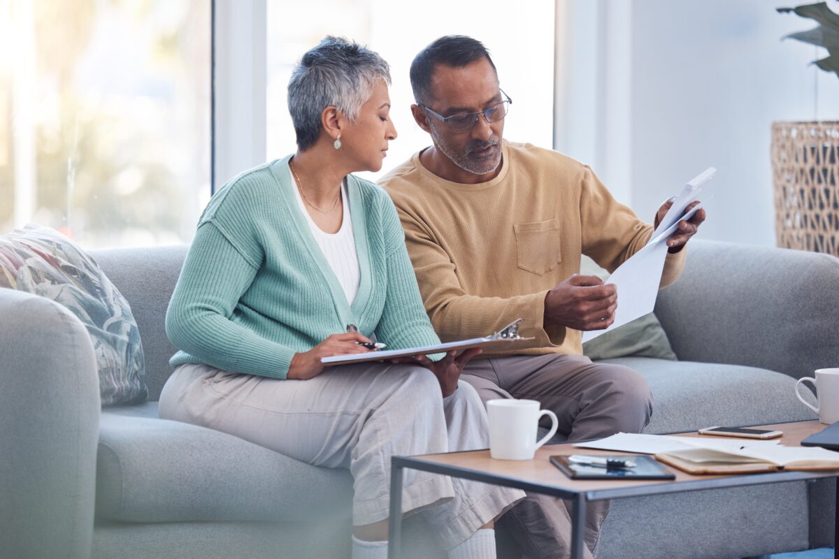 a photo of a couple looking at papers and making calculations