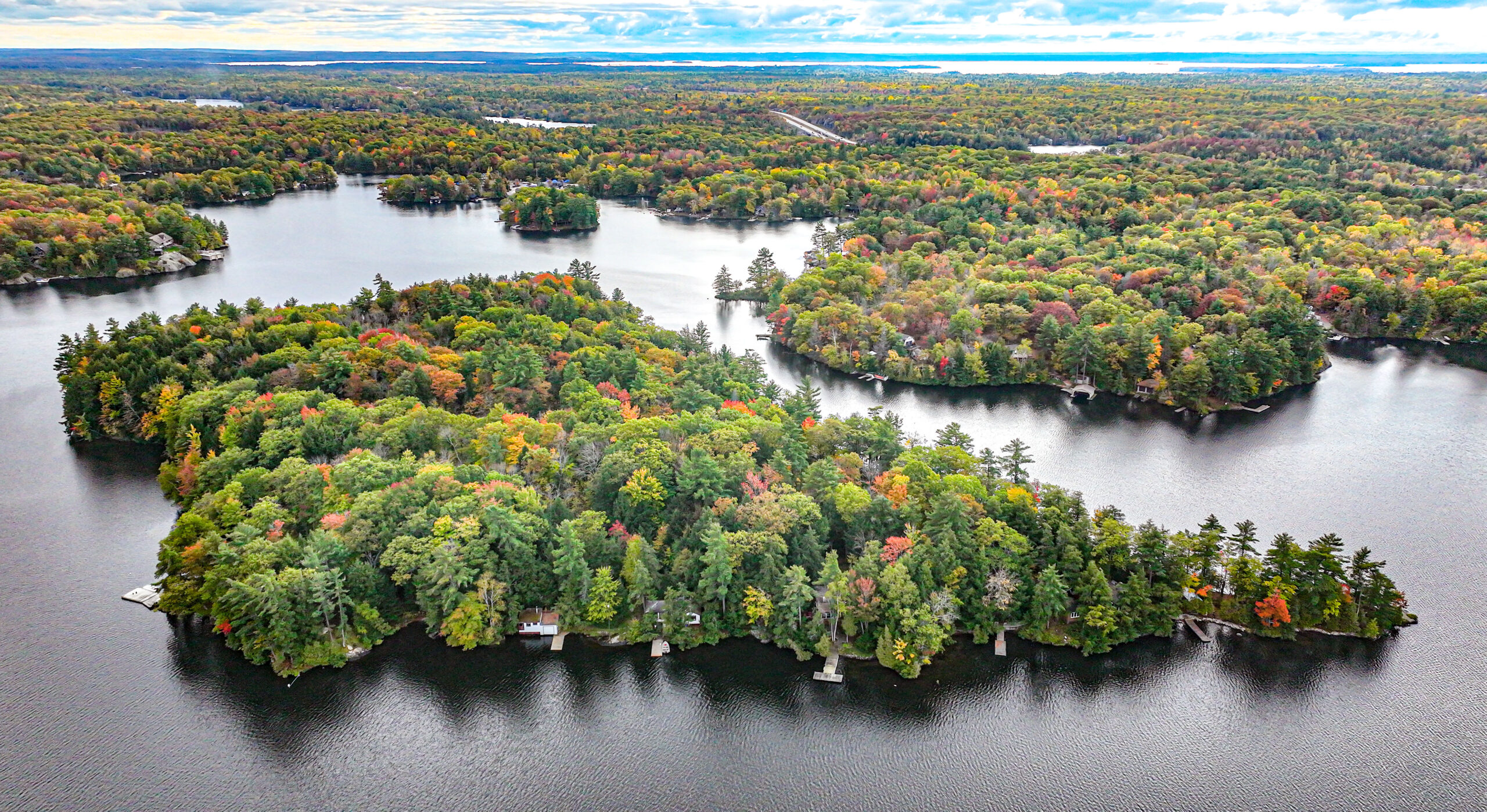 Aerial view of an island with lush green and orange trees