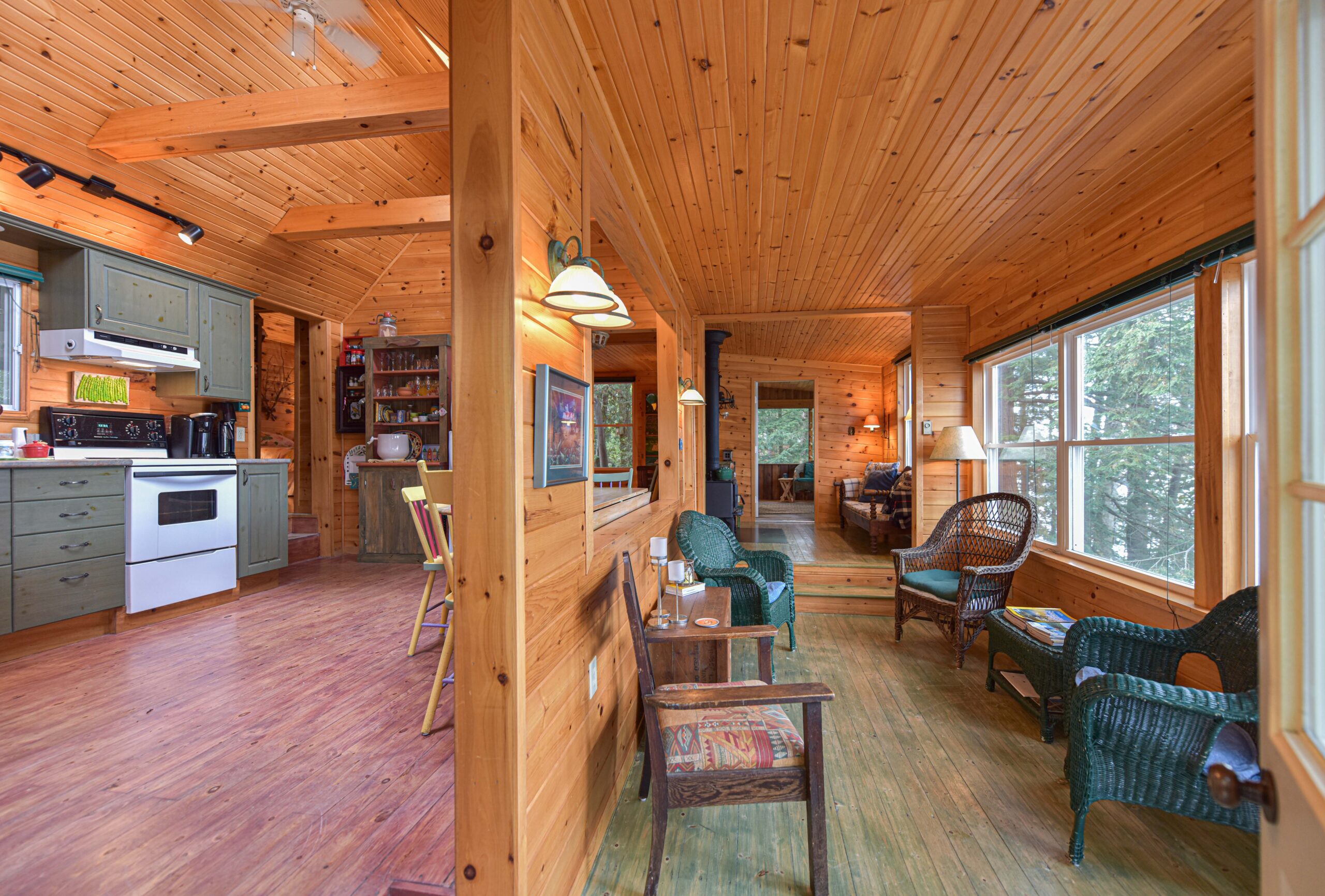 A wood wall separates the kitchen from a sitting room