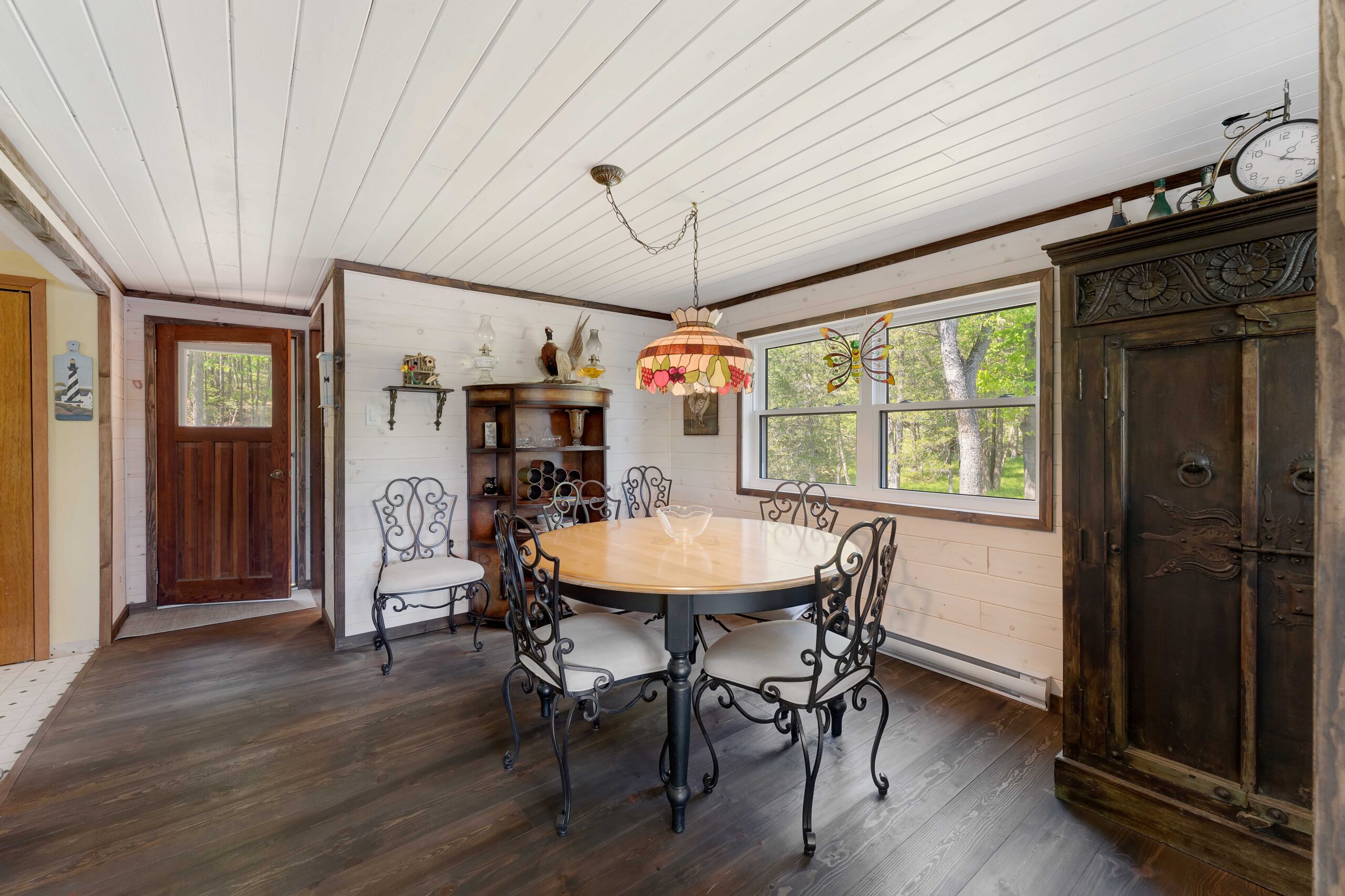 A small round dining table next to a window