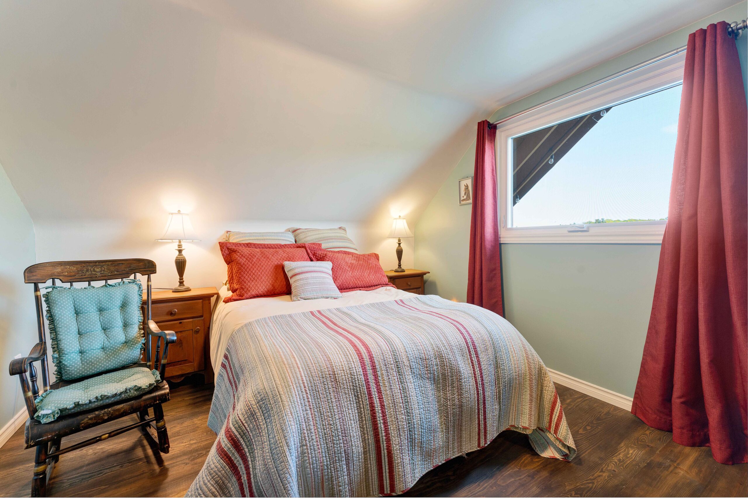 A red and blue striped bed in a blue room