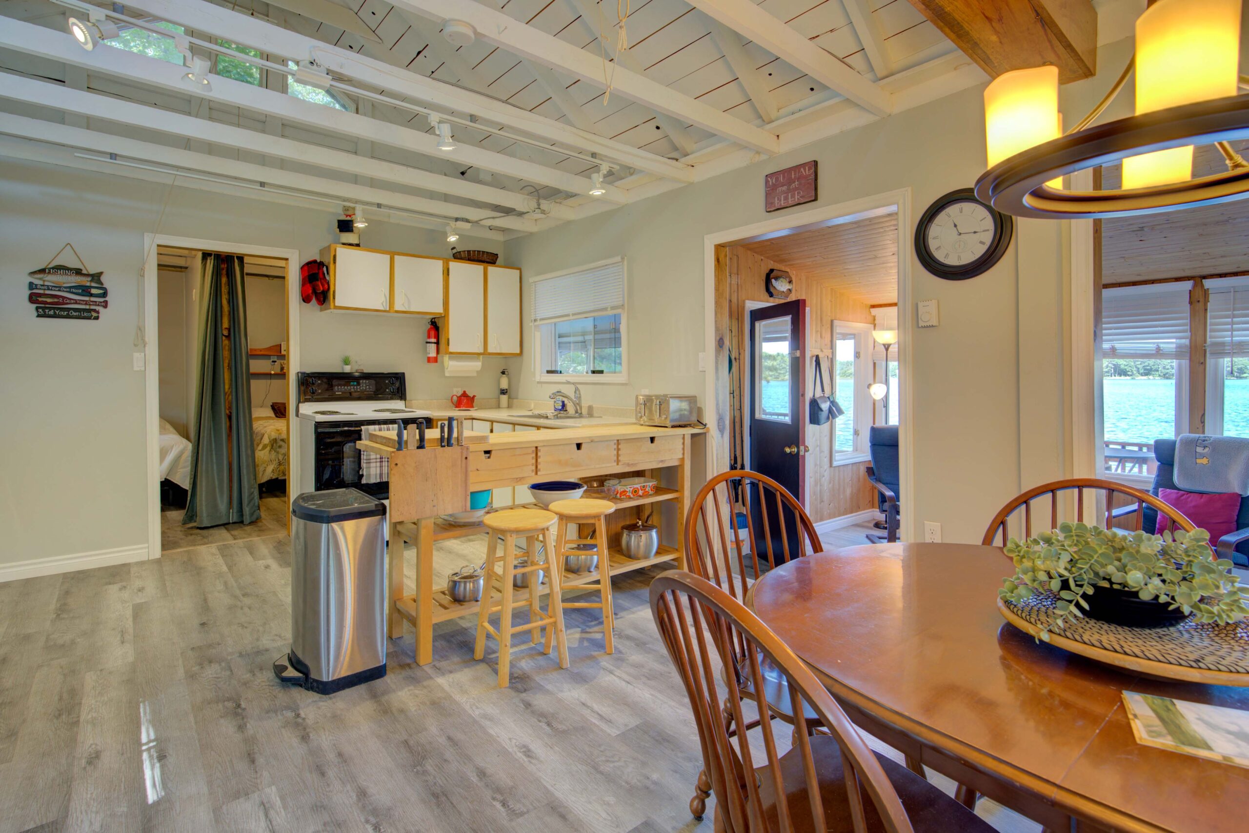 A wood sitting area with wood bar stools in a white kitchen