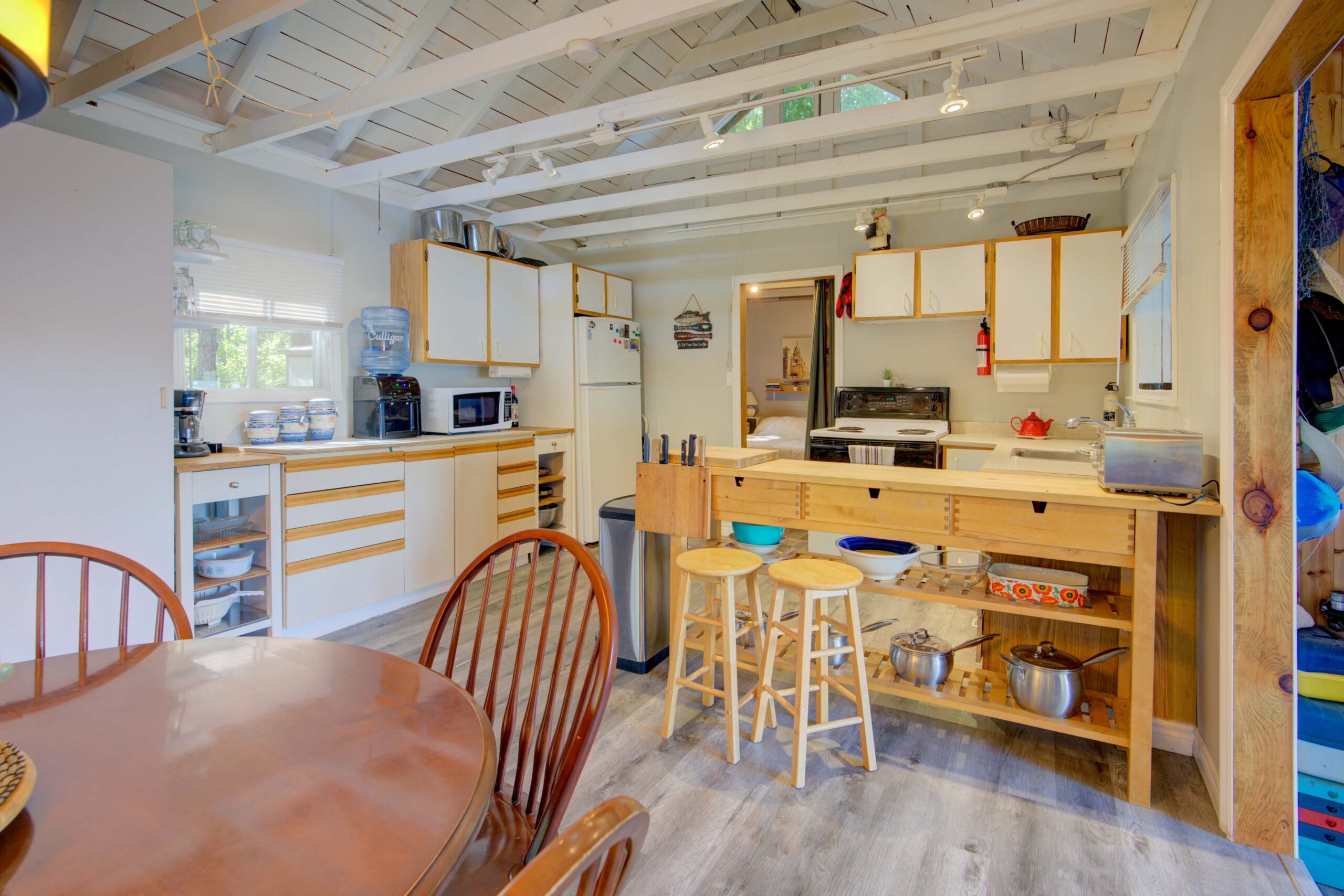 A wood and white wood kitchen with white vaulted ceilings