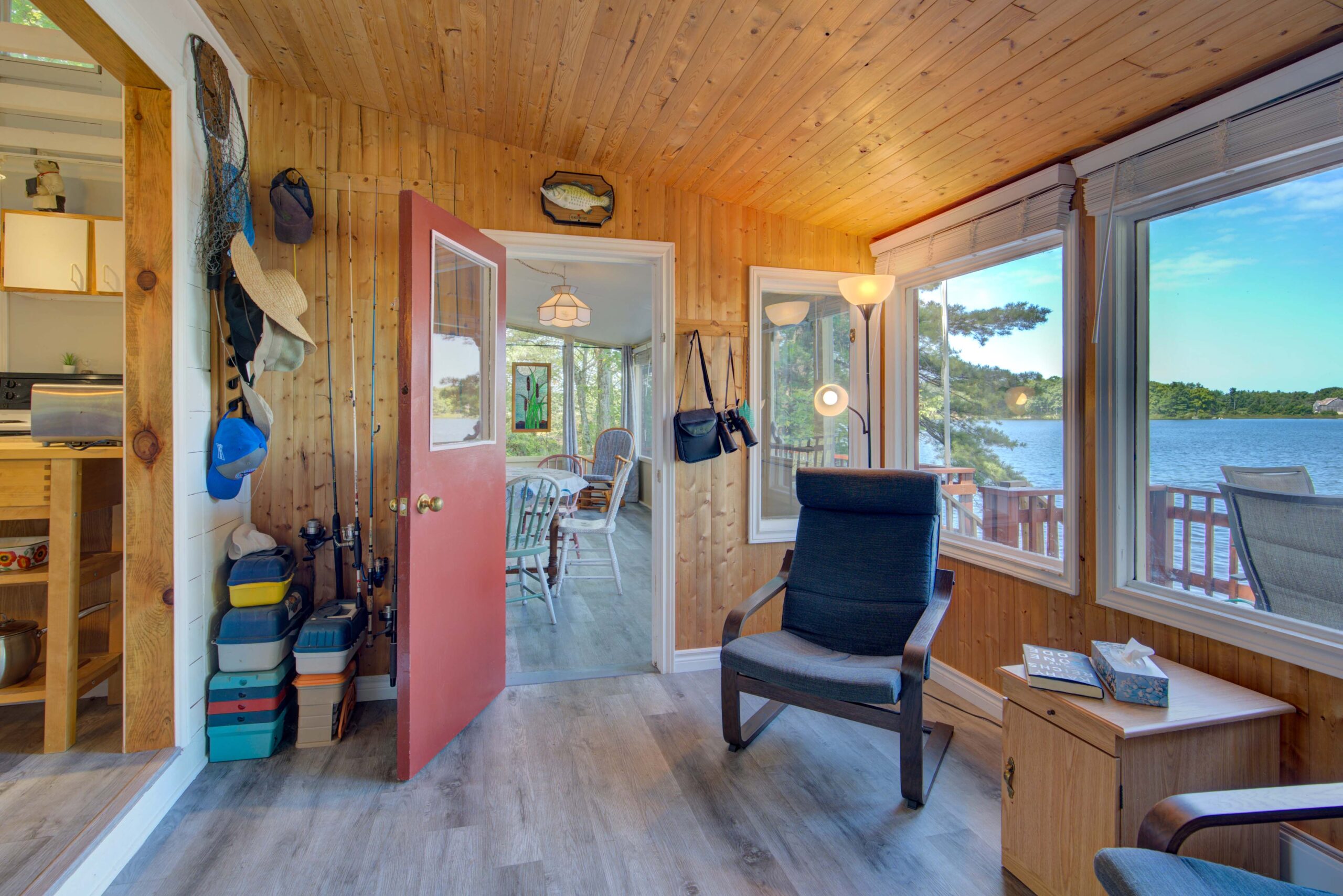 A black chair beside an open red doorway