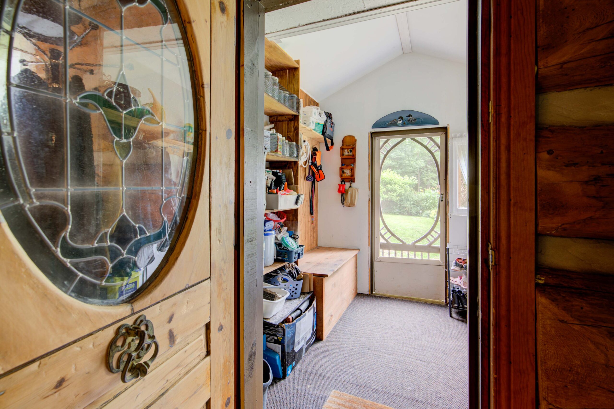 White front entryway with an open wood door