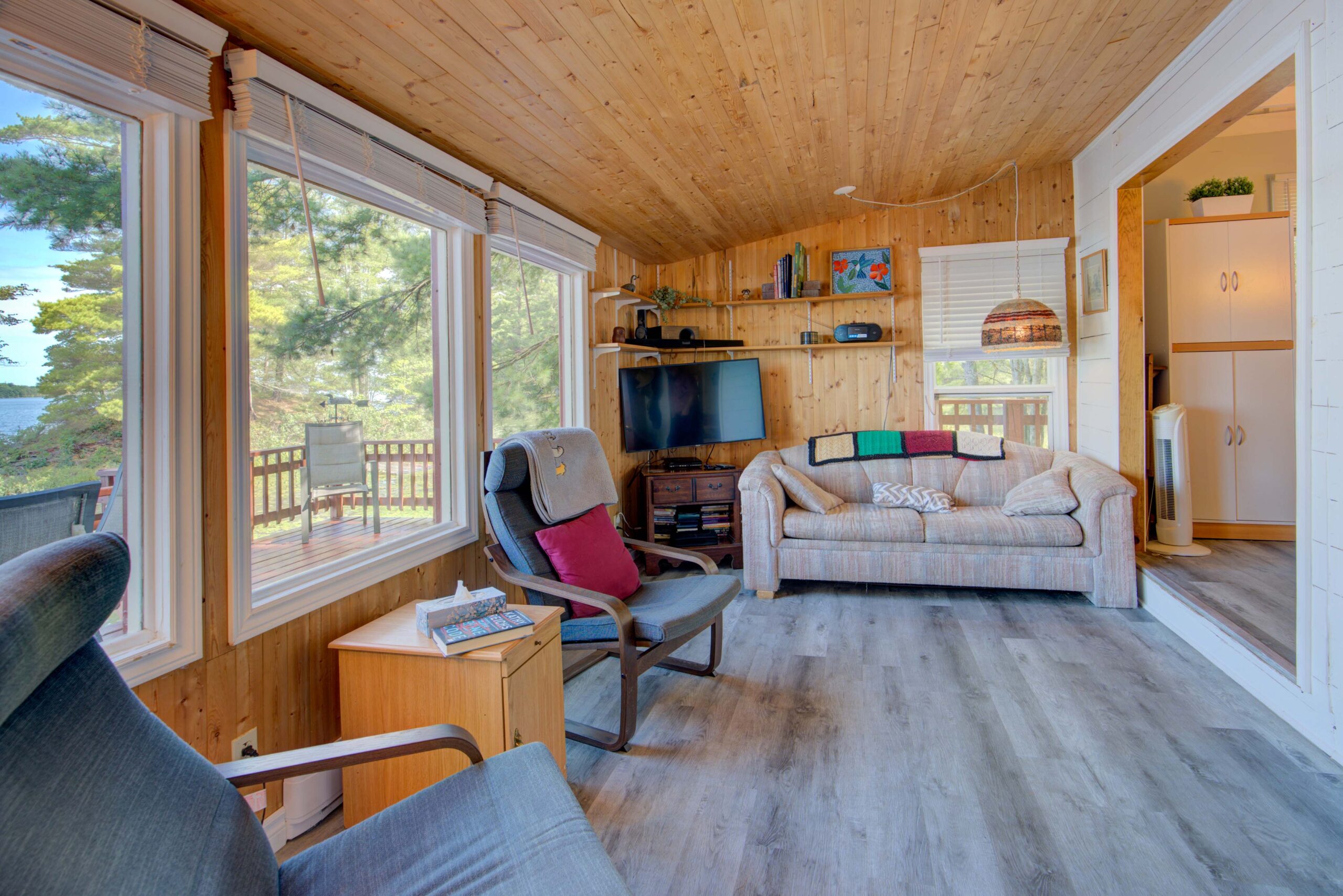 Two black chairs face away from a large window