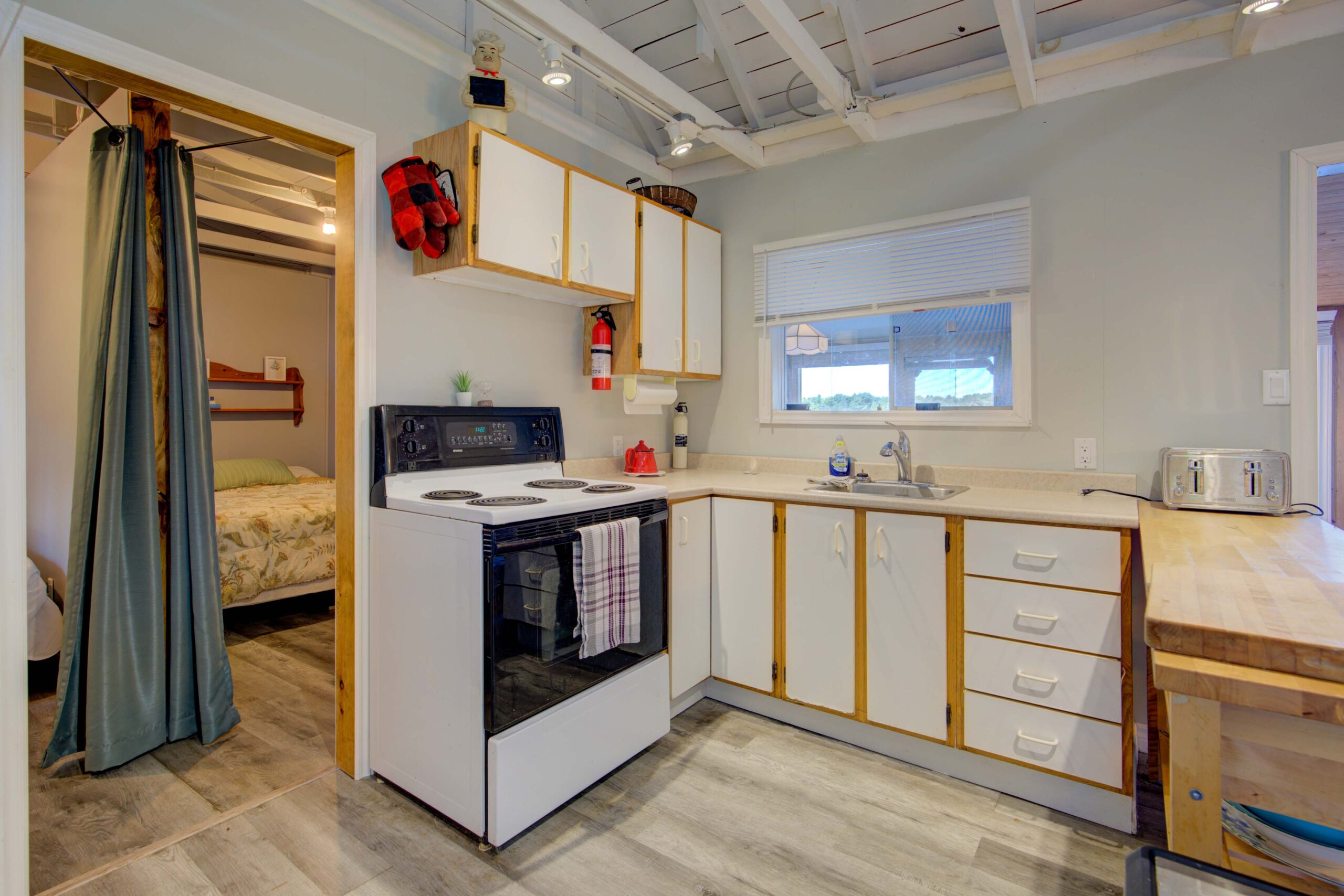A white oven next to white cabinets