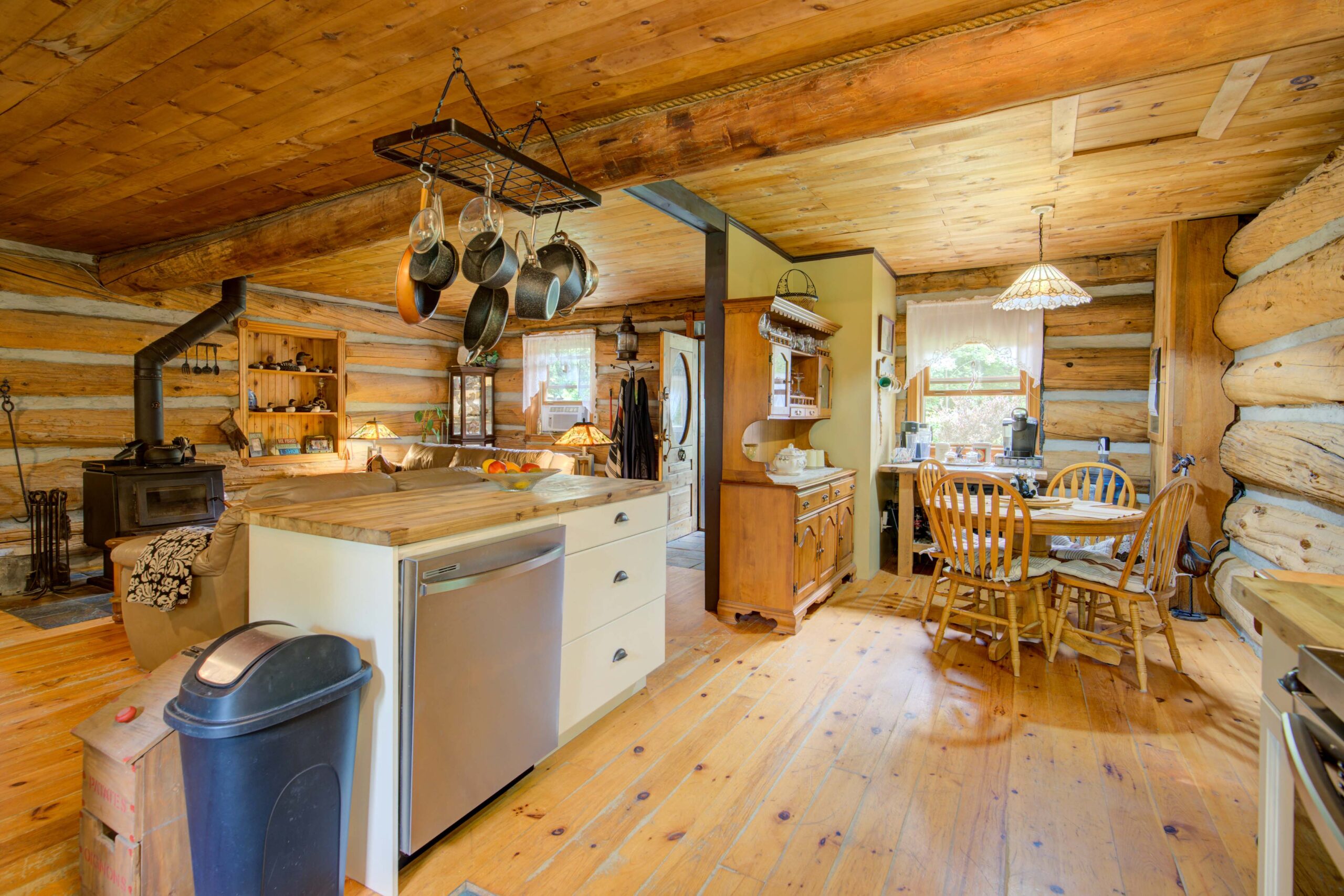 A wood-paneled kitchen with a stainless steel dishwasher