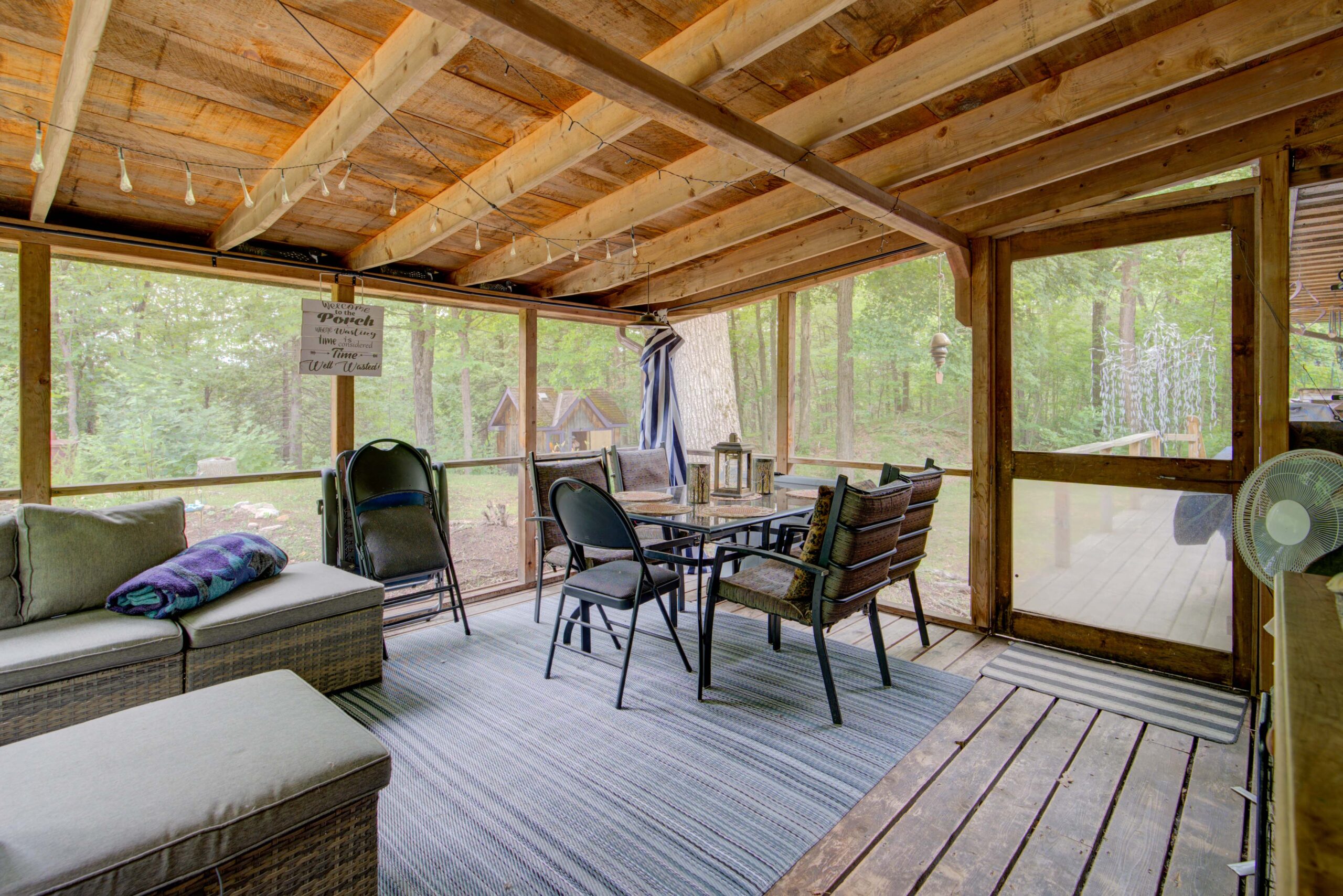 A small dining area in a screened-in porch