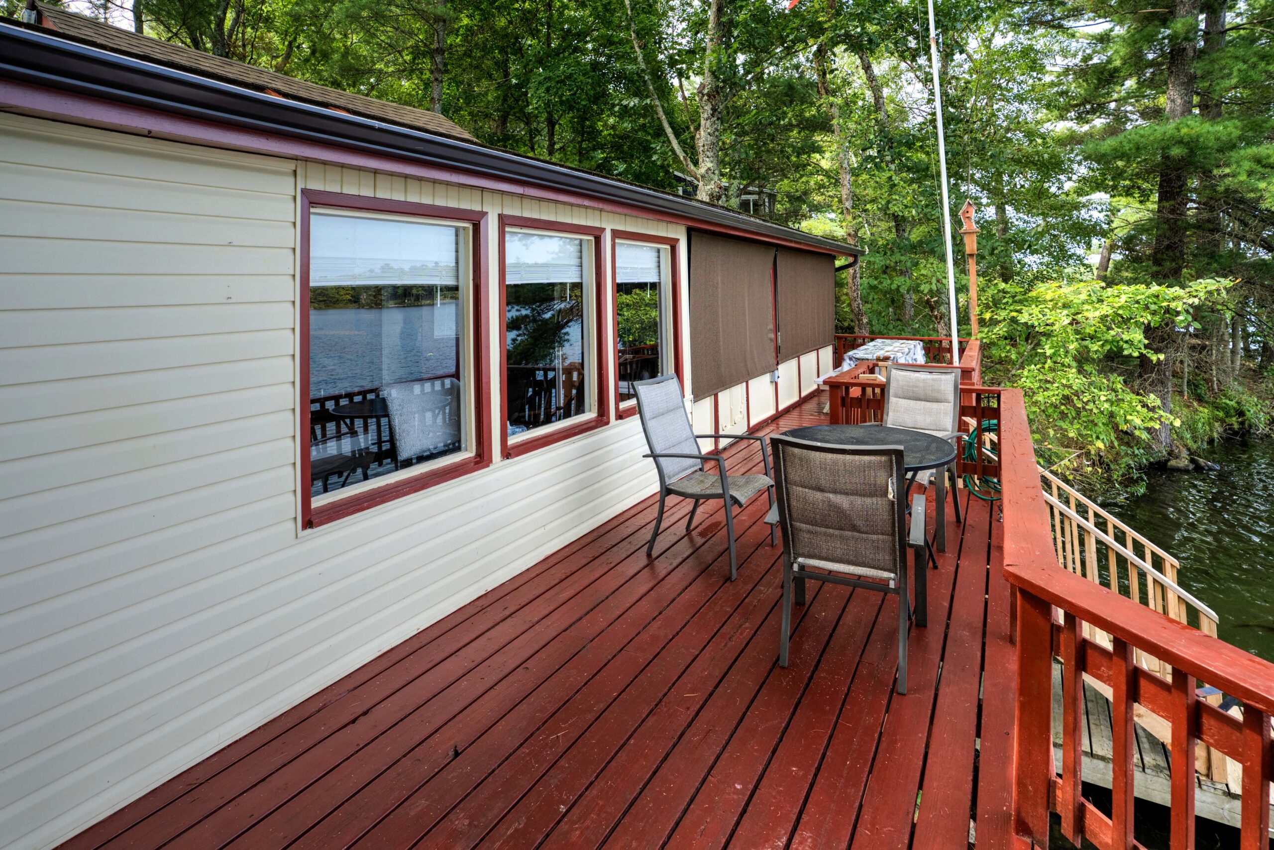 A red deck with an outdoor table on it