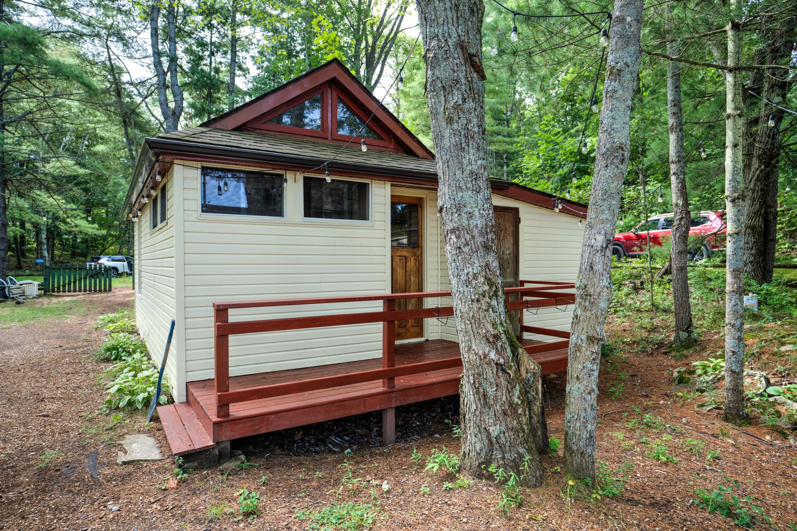 A small beige building with red trim