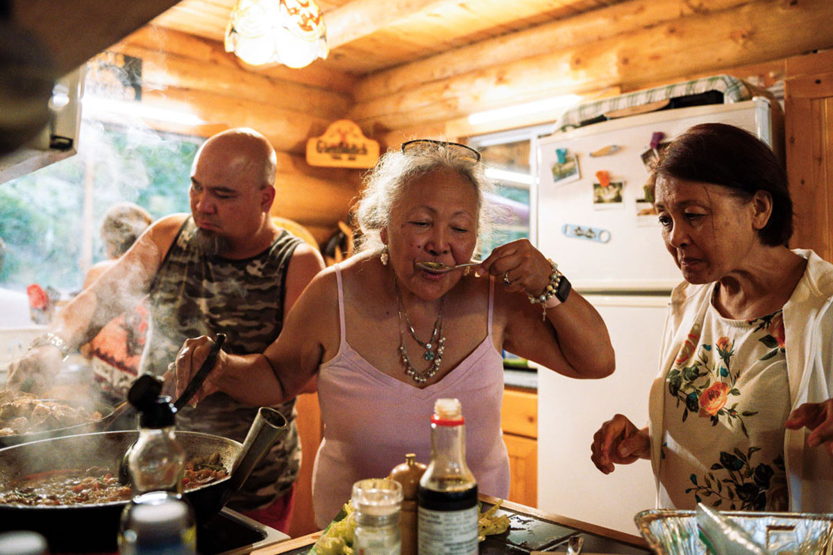Rose taste-tests something in the kitchen