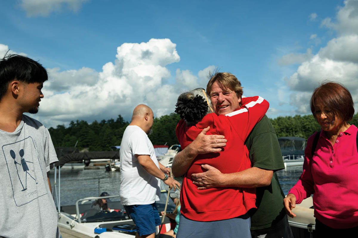 Mike hugs a family member on the dock