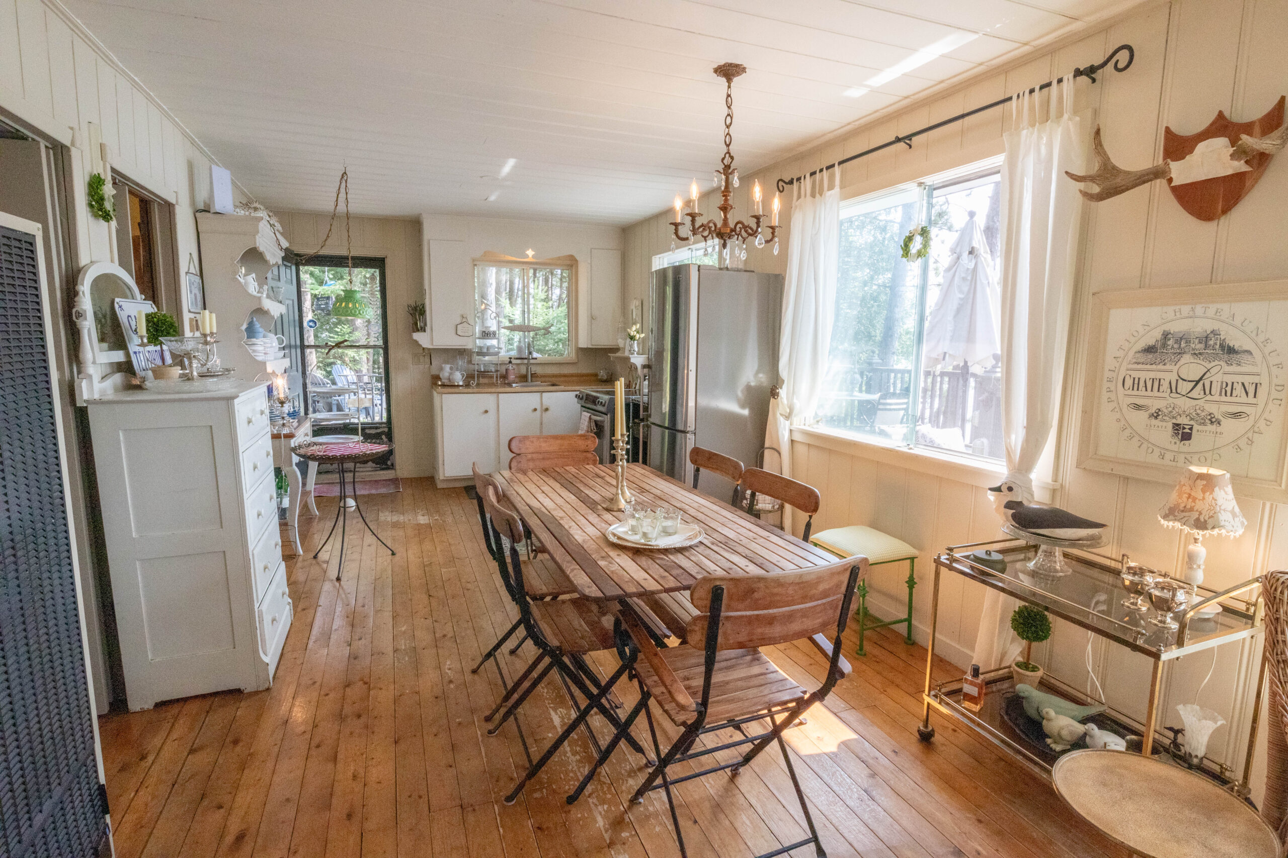 A long rustic wood table beside a window