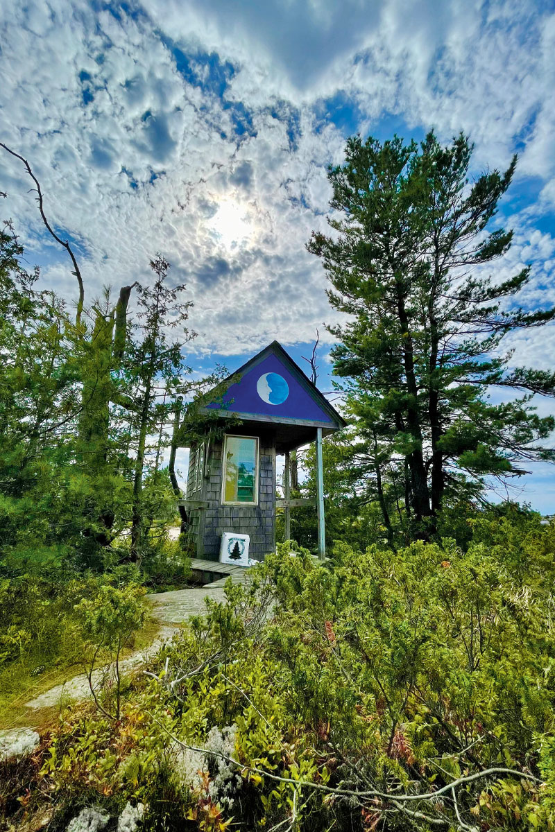 The exterior of an outhouse painted with the facade of the painter's grandfather