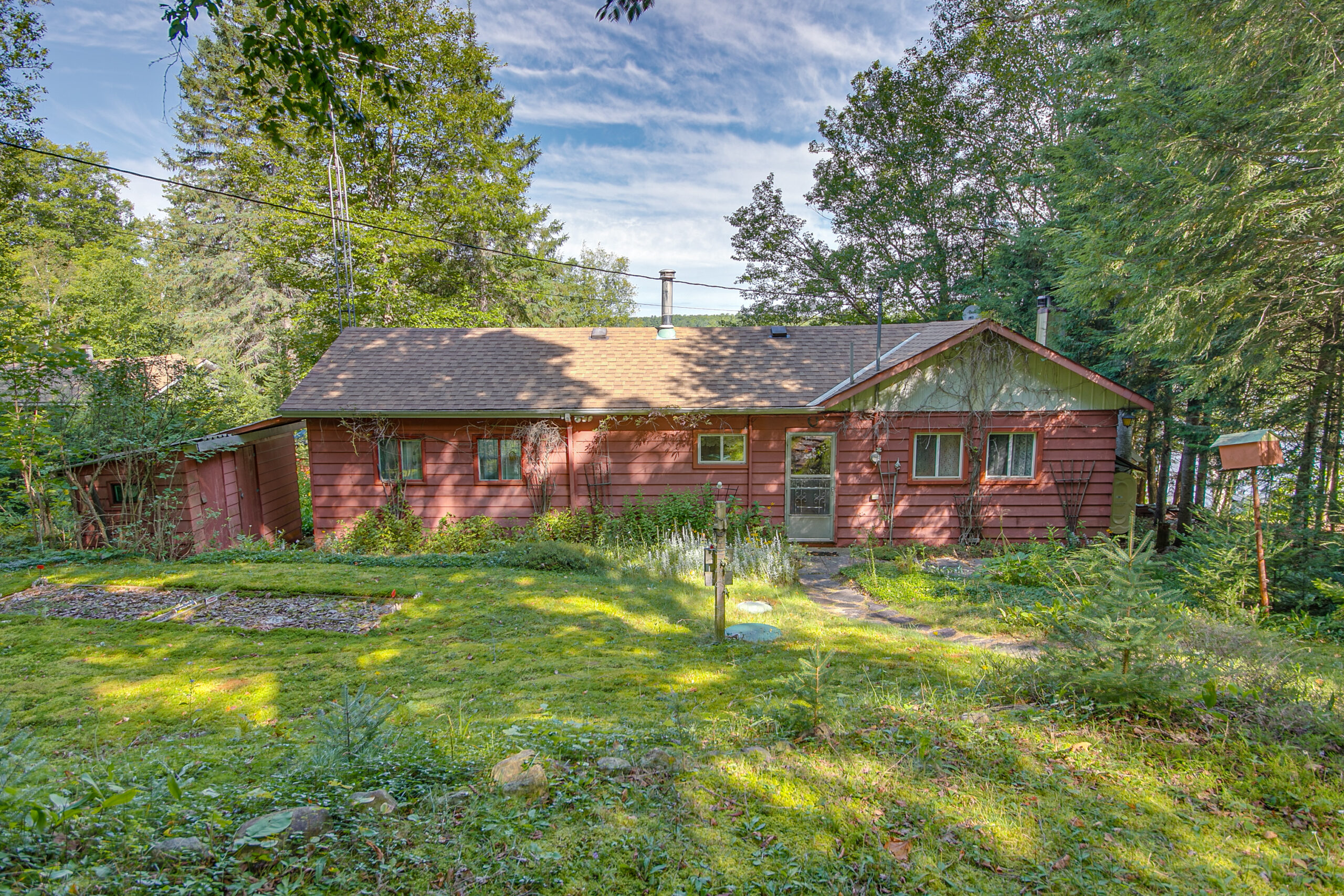 A red bungalow cottage with green trim