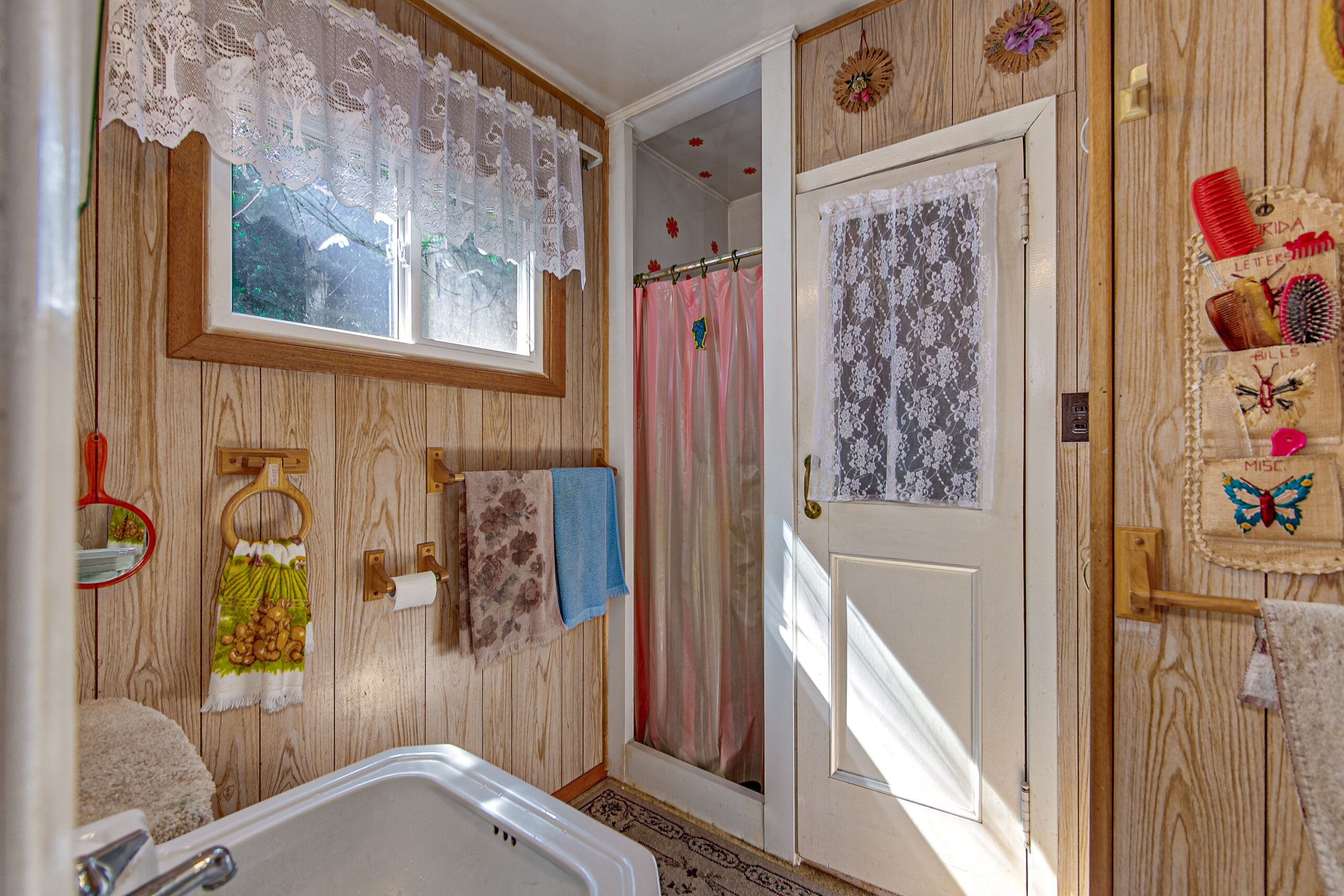 a small wood bathroom with a white door