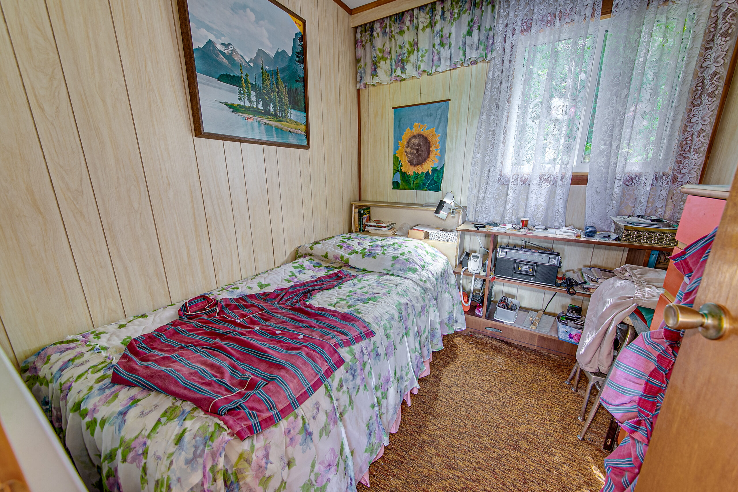 A floral bed in a small cream room