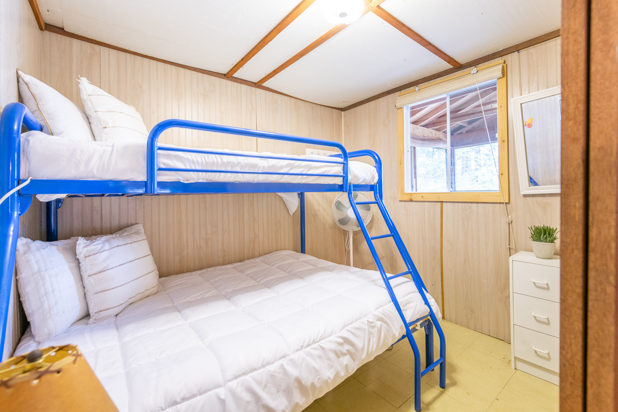 White bunk beds on a blue metal frame