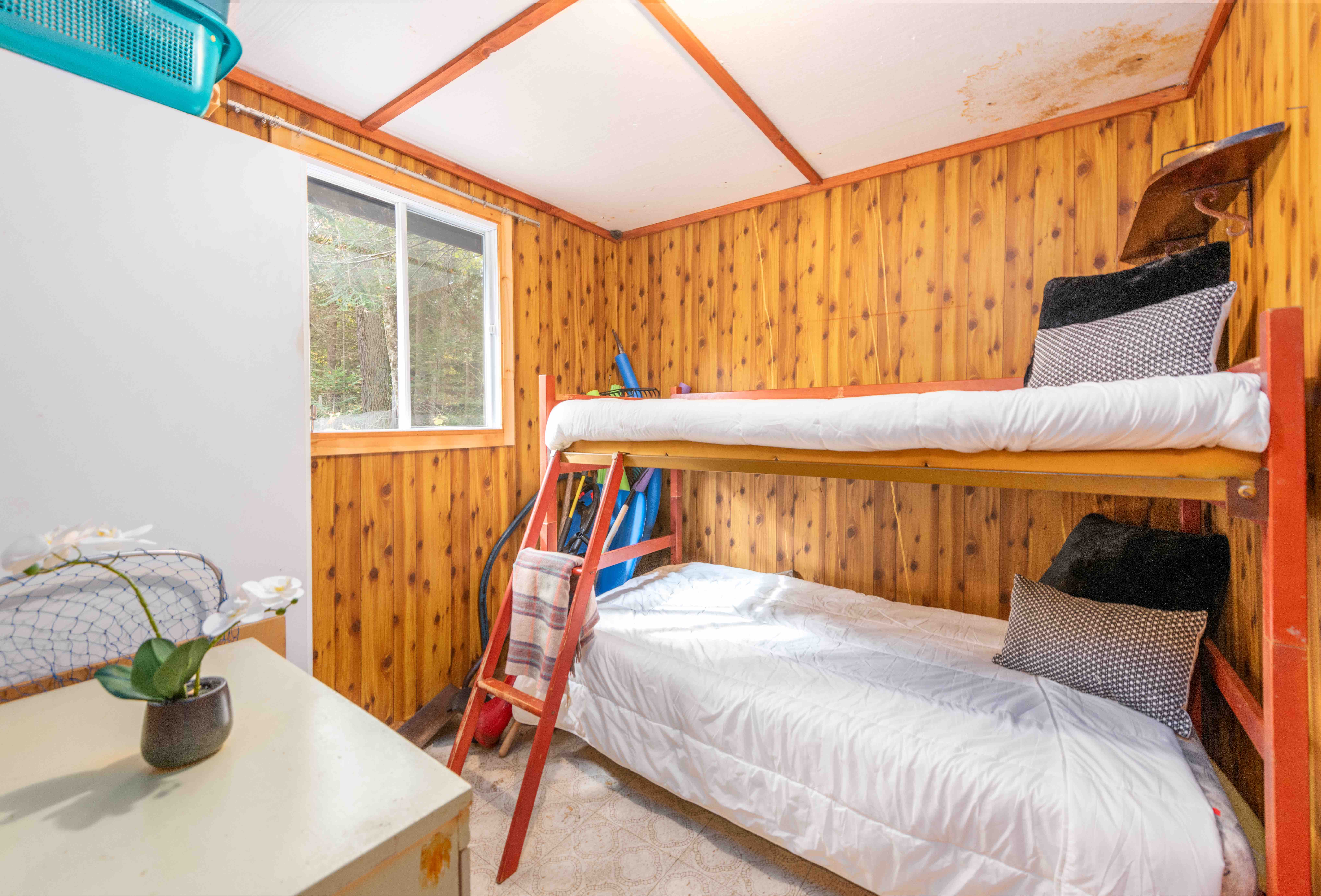 White bunk beds on a red wire frame