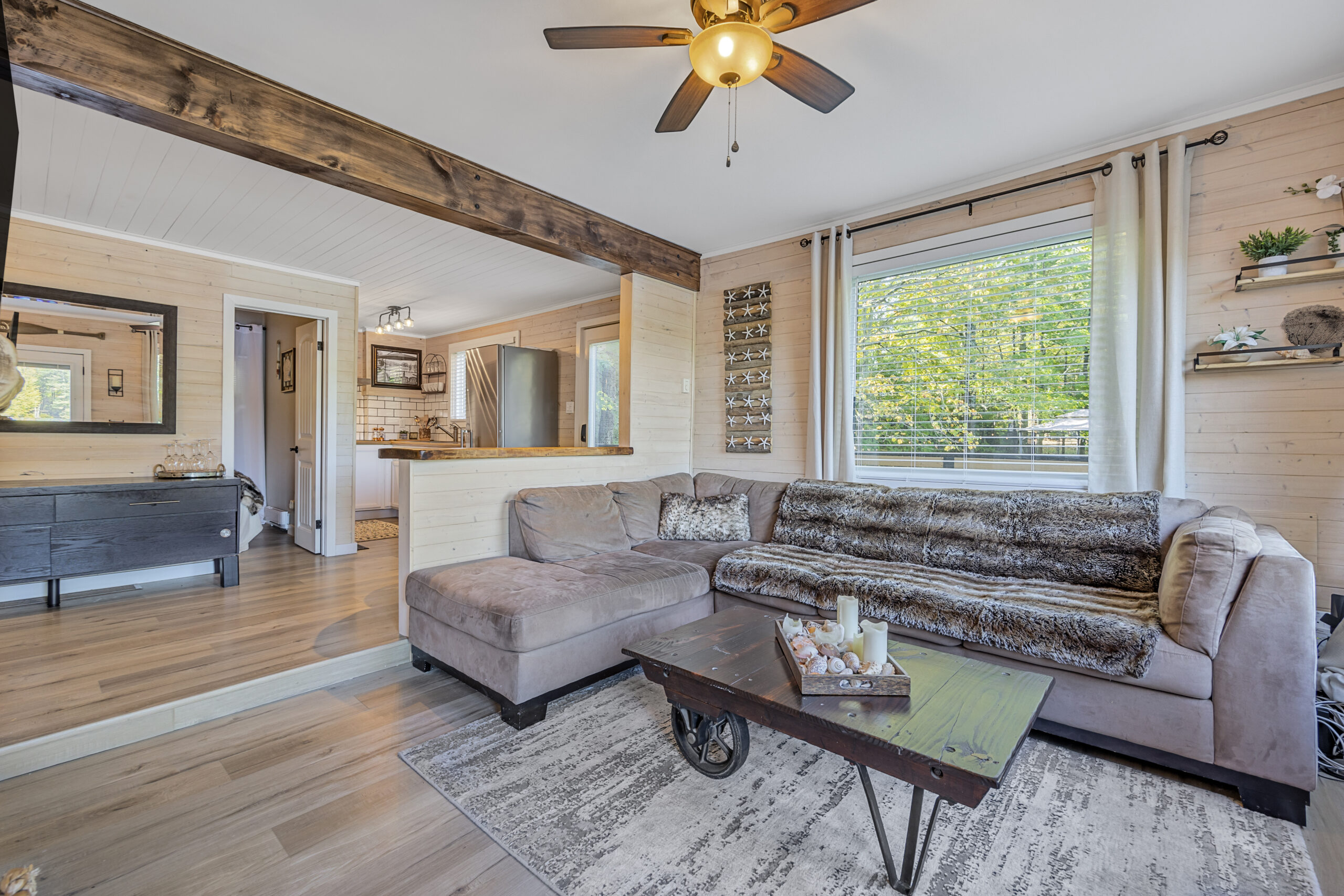 An L-shaped grey couch in a bright living room