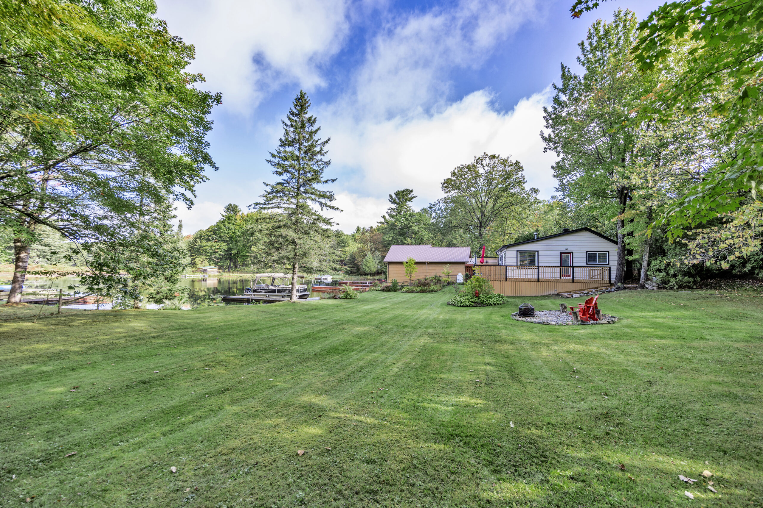 A large green grassy area with a small white cottage
